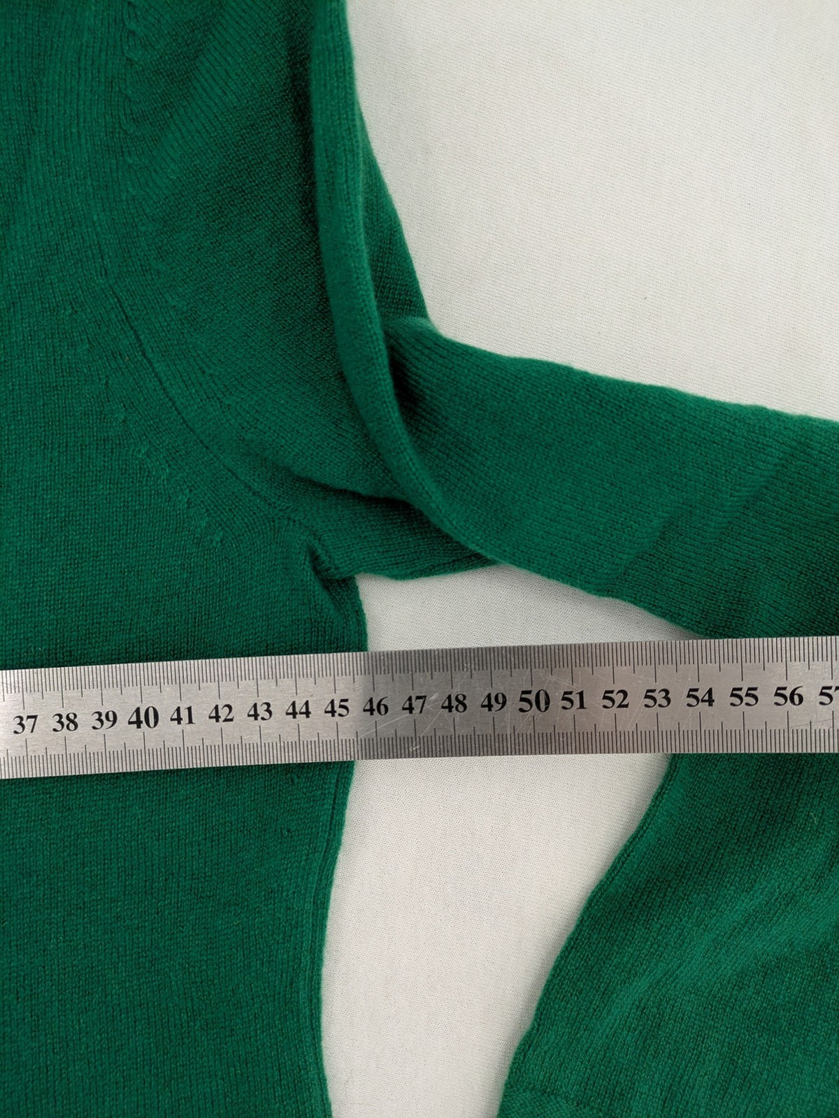 Pullover green cashmere turtle neck jumper with classic V-neck and long sleeves.