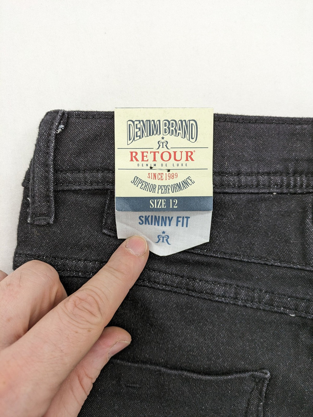 Skinny black straight jeans with distressed details and logo, made from durable denim.