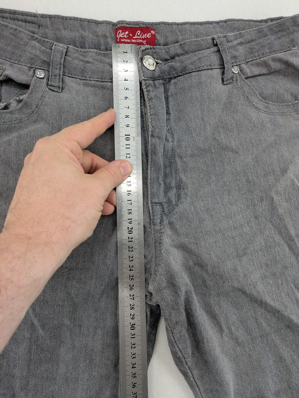 Jet Line grey straight jeans with embellished back pockets and frayed hem details.