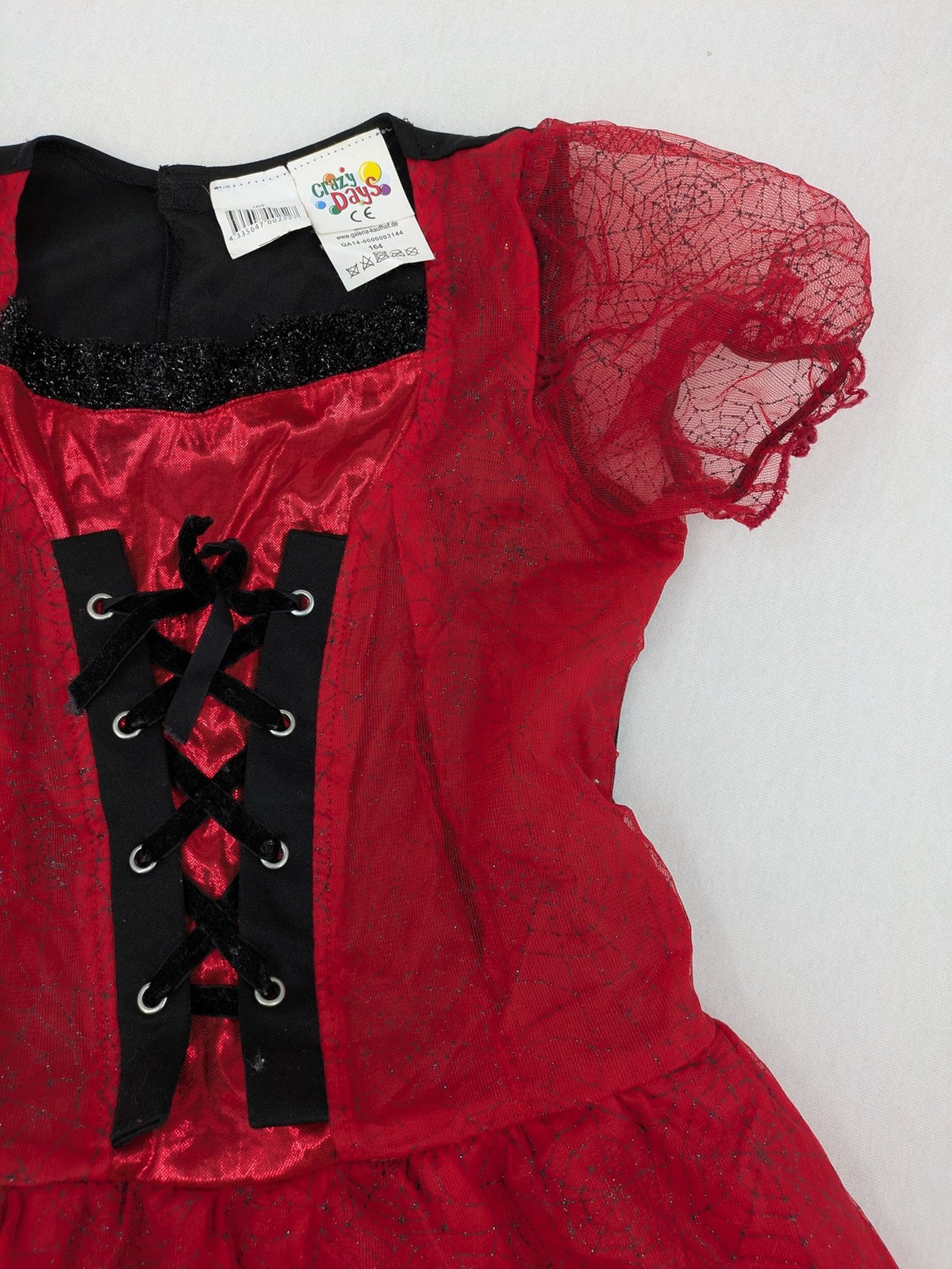 Perfekt red and black costume dress with corset lacing and spiderweb sleeves.