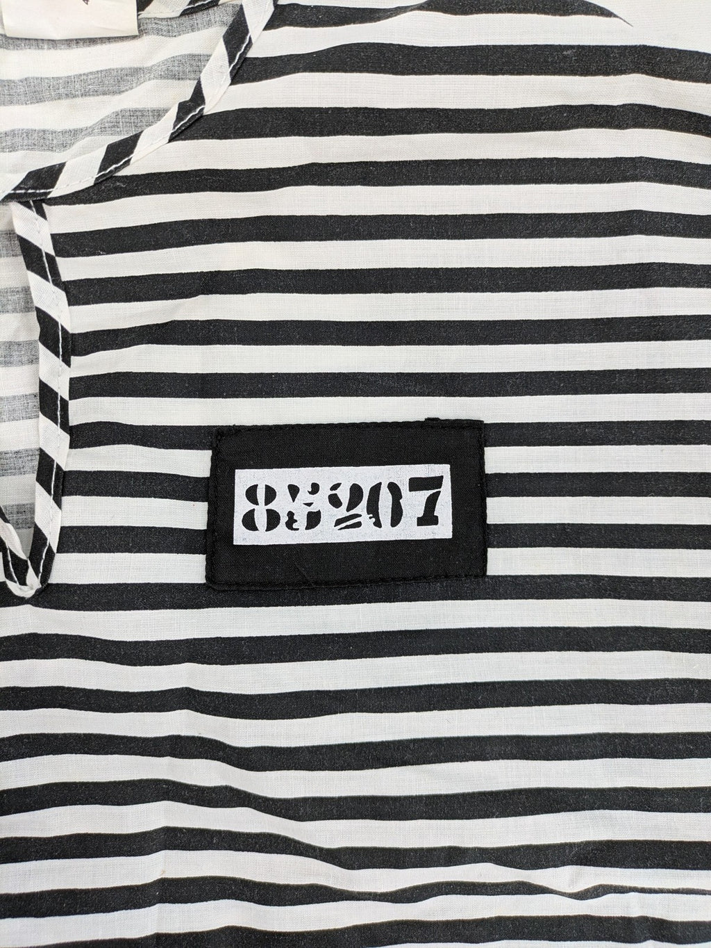 Rubie's costume set black and white striped with prisoner number patch on chest.