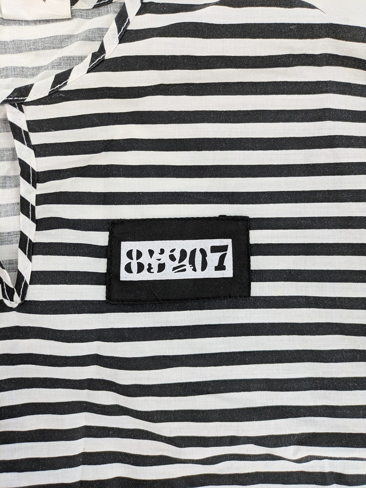 Rubie's costume set black and white striped with prisoner number patch on chest.