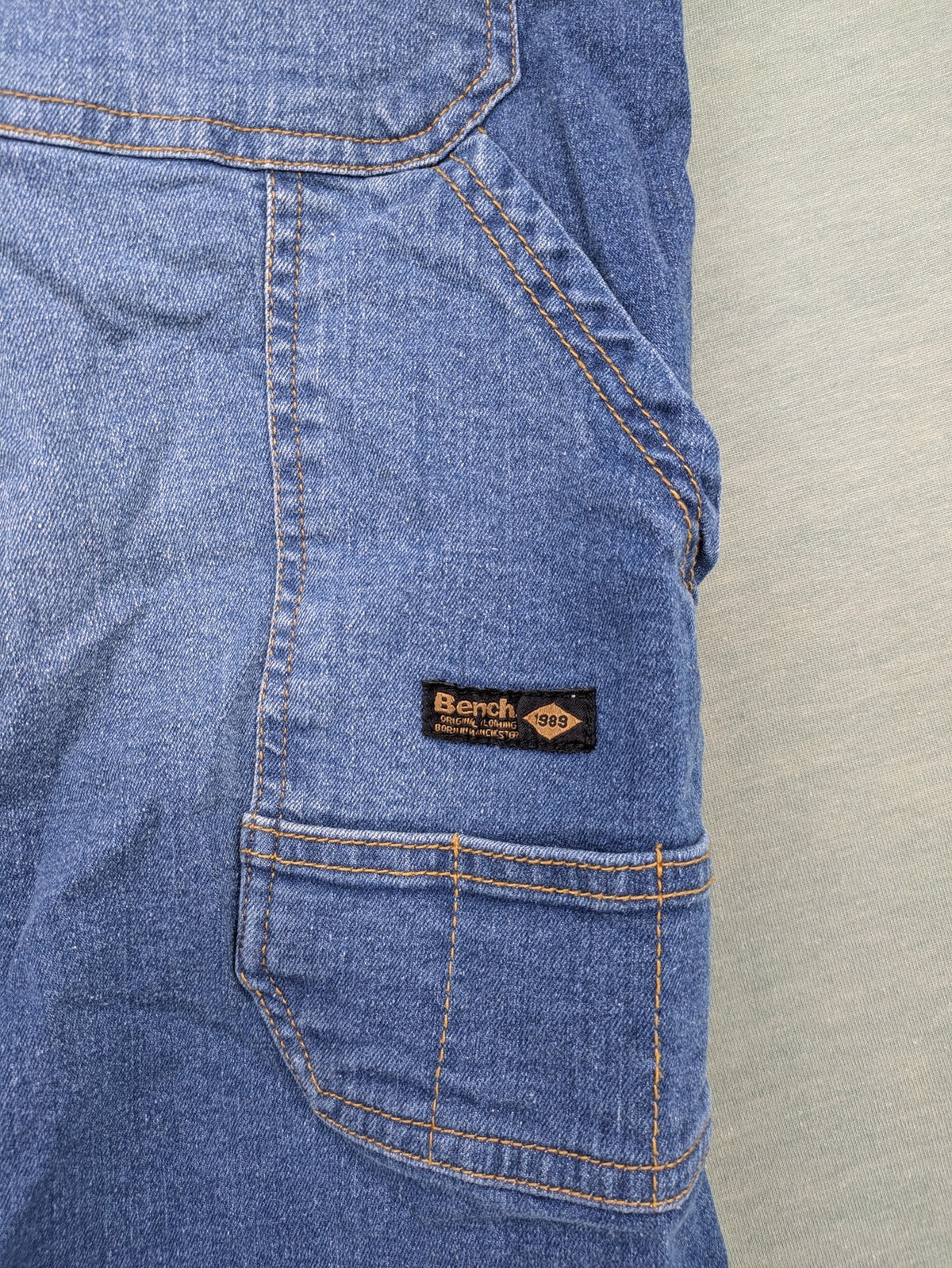 Bench blue straight jeans with reinforced knees and multiple cargo pockets.
