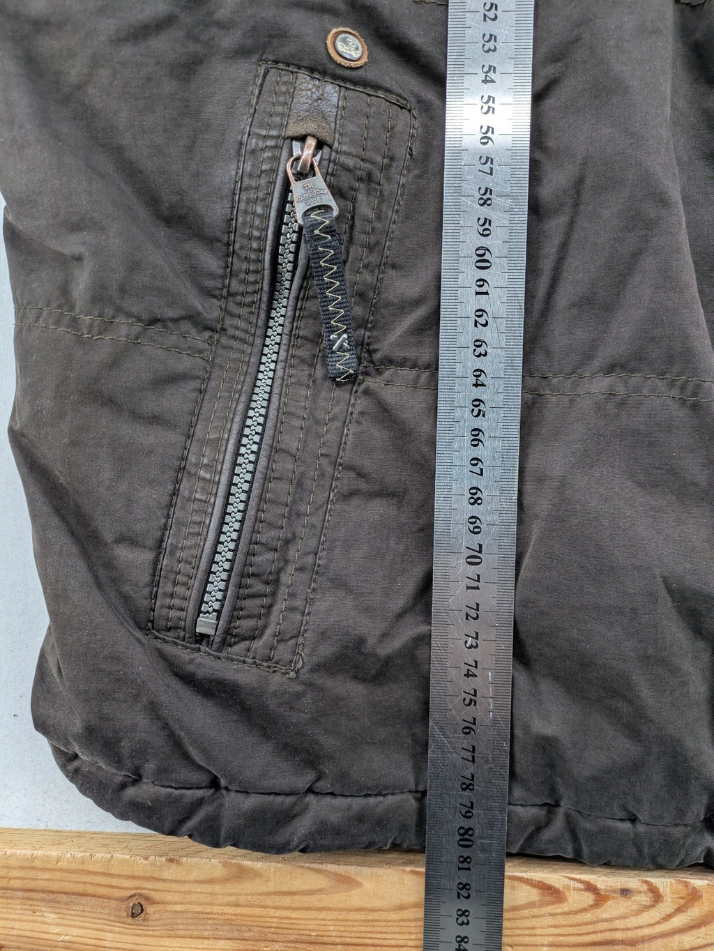 Gate One brown field jacket with plaid lining, multiple pockets, and zip-button closure.