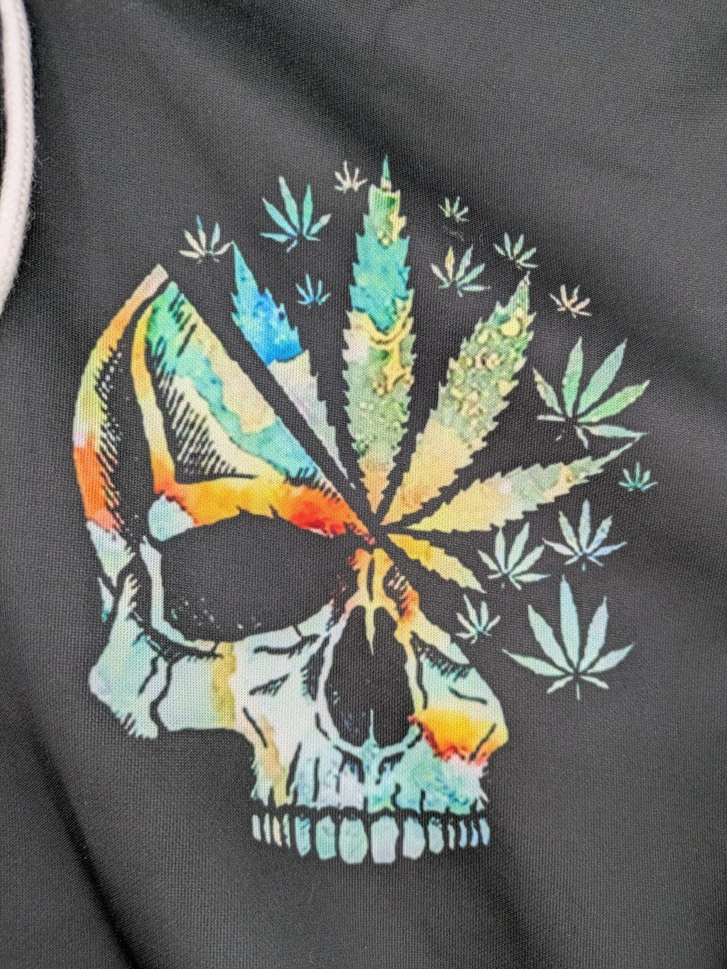 Skull tie-dye hoodie blue green with cannabis leaf graphic and bold text.