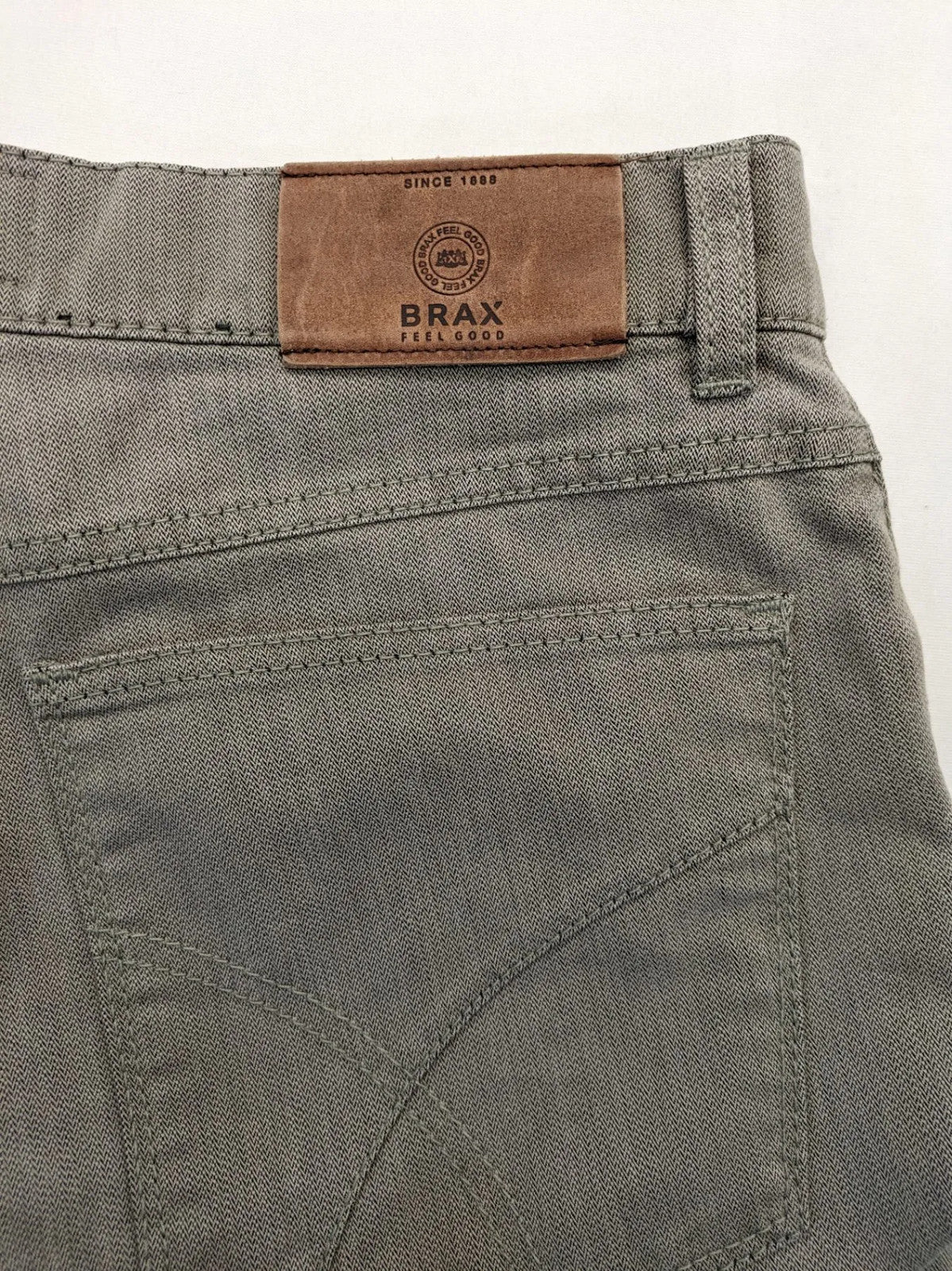 BRAX grey straight jeans 5-pocket design with zipper fly and soft fabric.