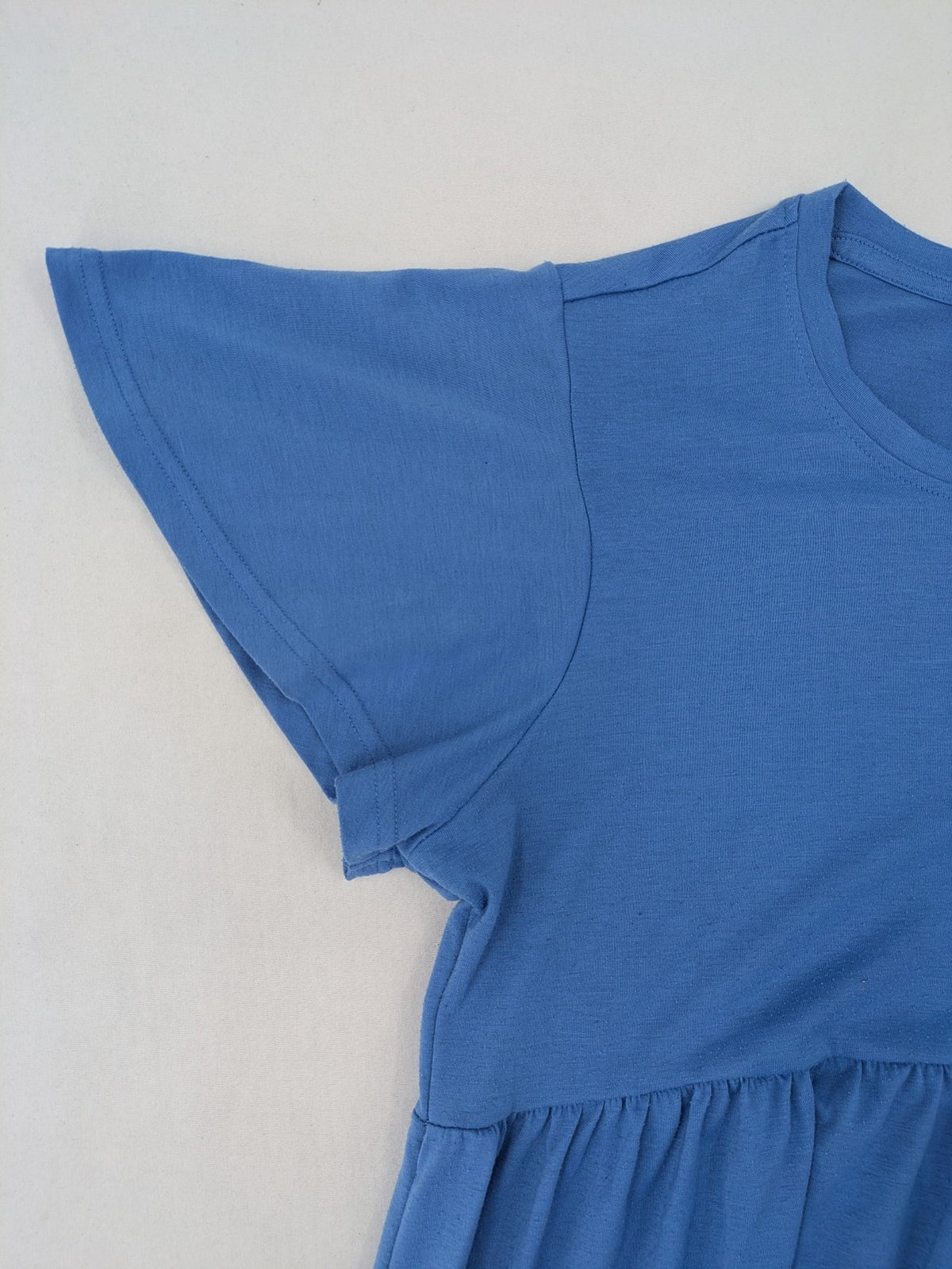 Infinity blue T-shirt dress A-line cut with playful flutter sleeves and soft stretch fabric.