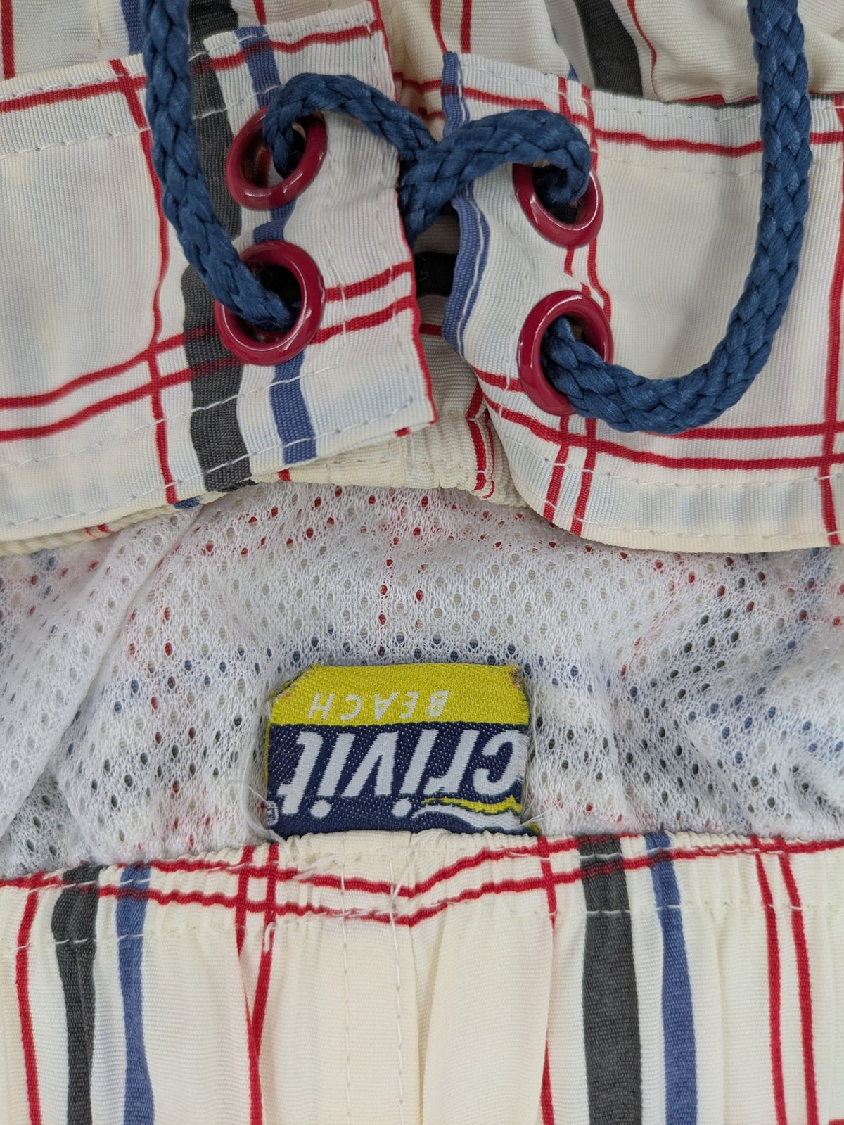 Crivit multi-coloured board shorts with classic check pattern and adjustable drawstring waistband.
