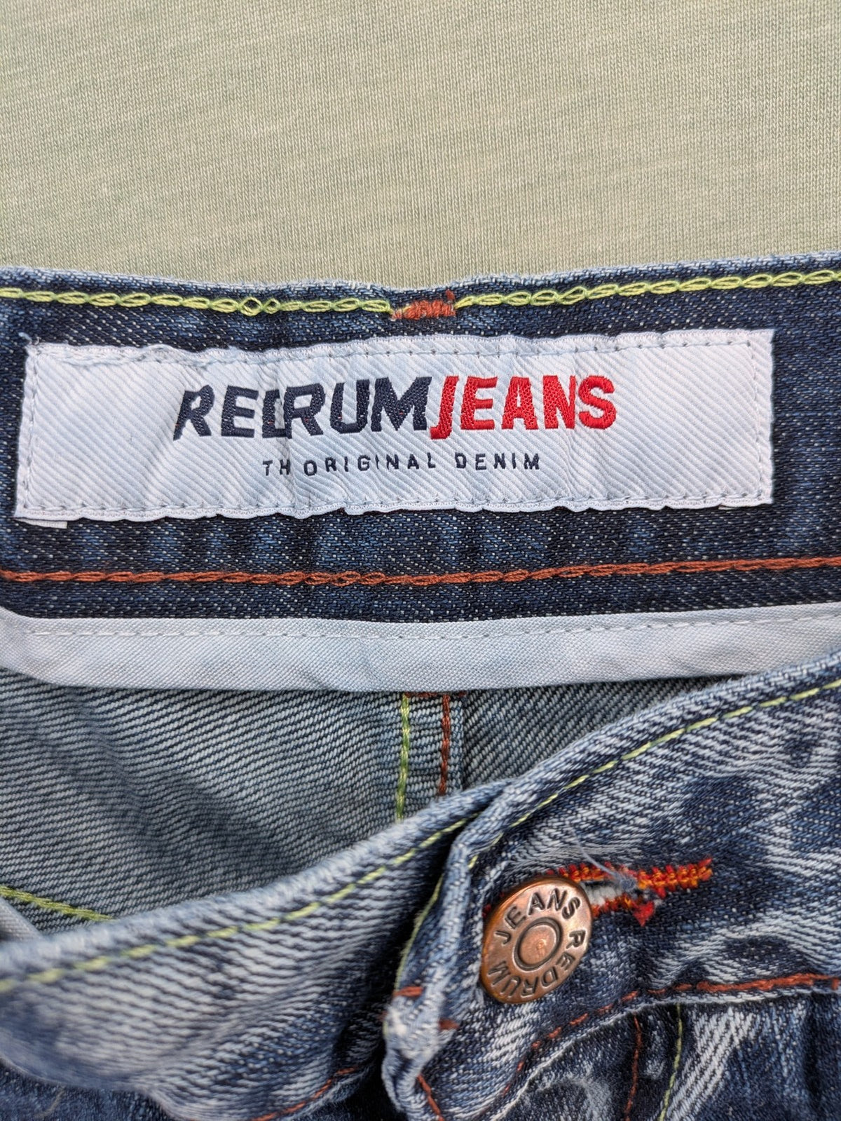 Y2K blue straight jeans with colorful logo embroidery and baggy fit.