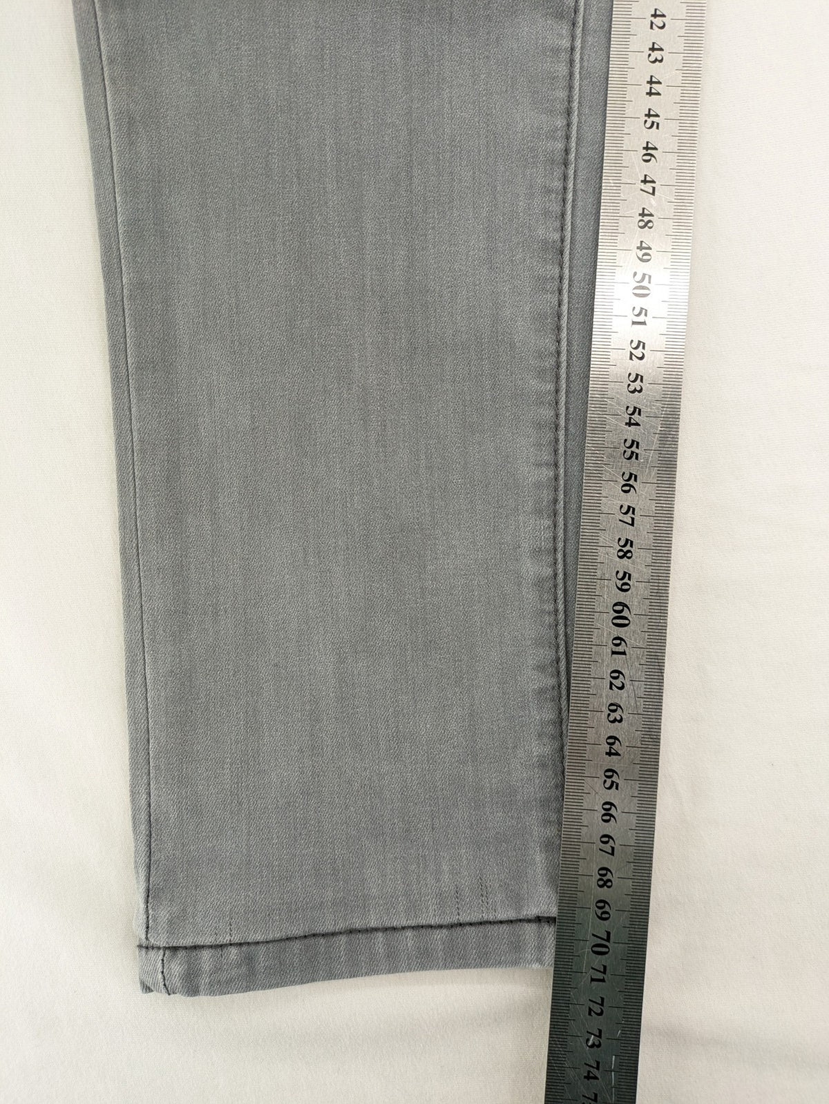 Born Rich grey slim fit jeans with logo patch and washed denim texture.