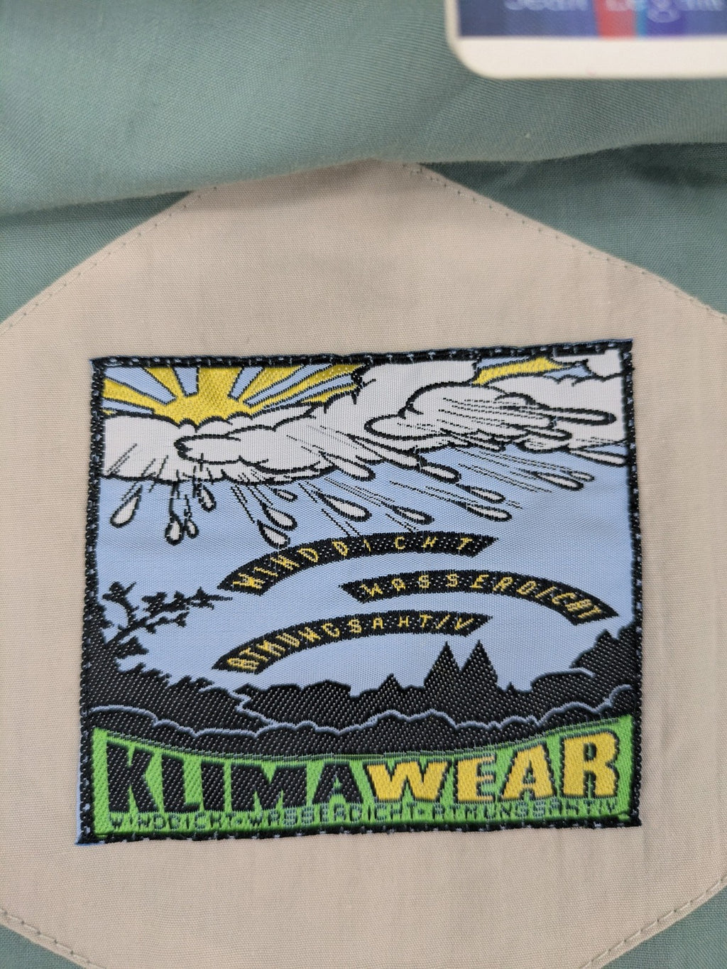 Klima green jacket vintage style, windproof, waterproof, with hidden hood and multiple pockets.