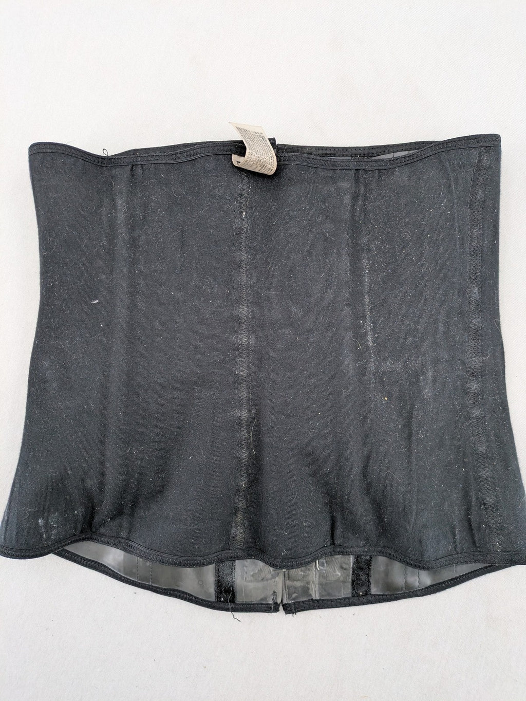 Faja black shapewear body shaper with multiple hook-and-eye closures and latex core.