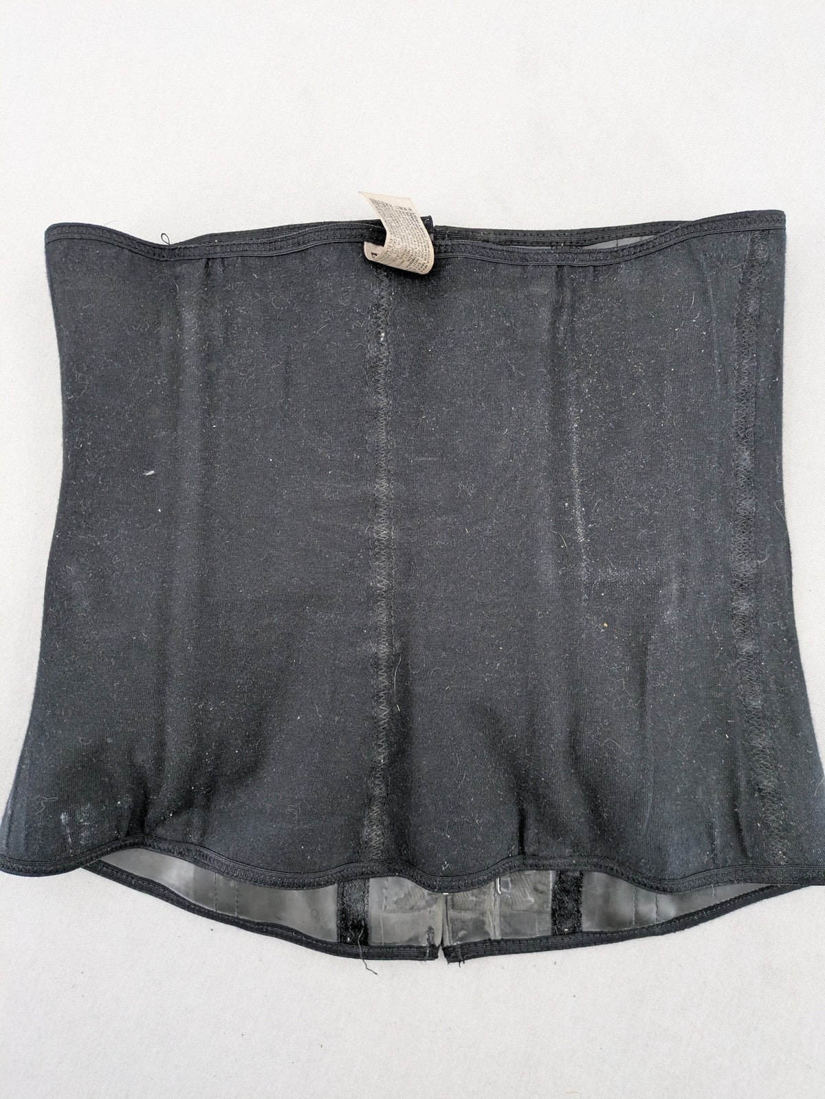 Faja black shapewear body shaper with multiple hook-and-eye closures and latex core.