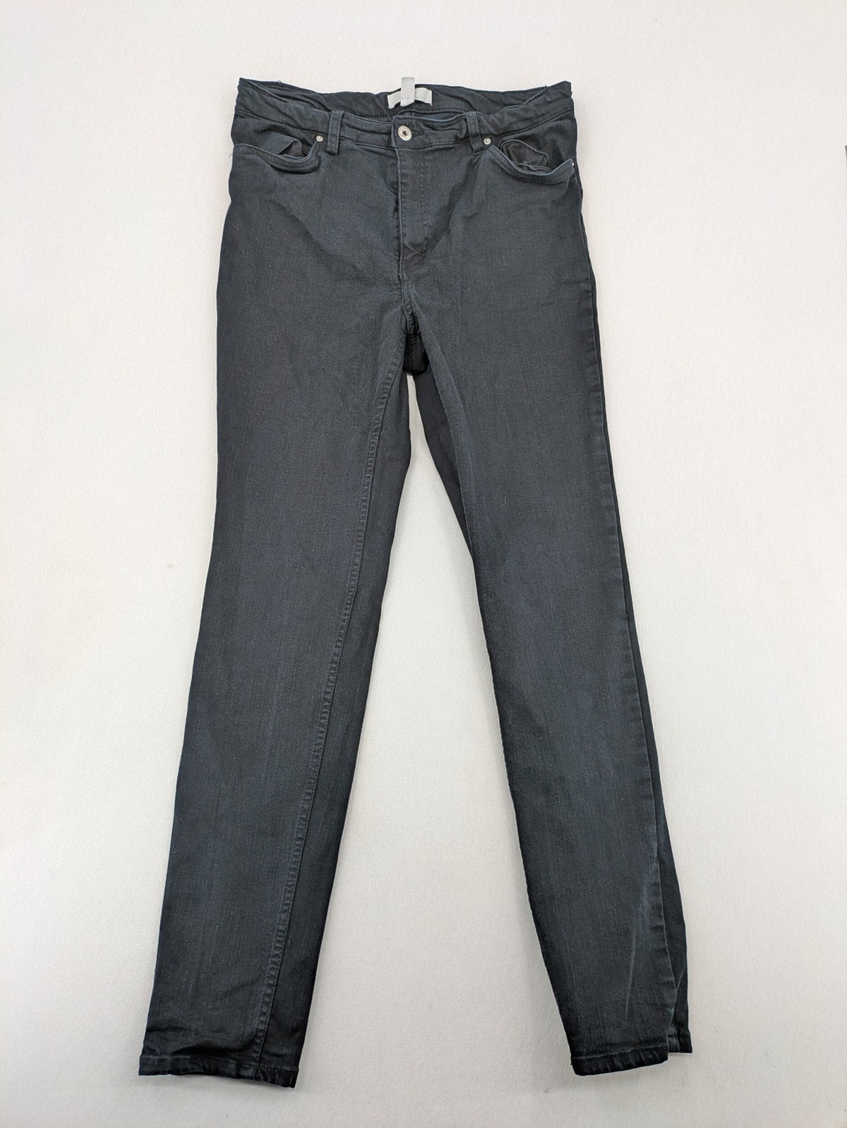 H&M grey skinny jeans with faded wash and soft stretch denim material.