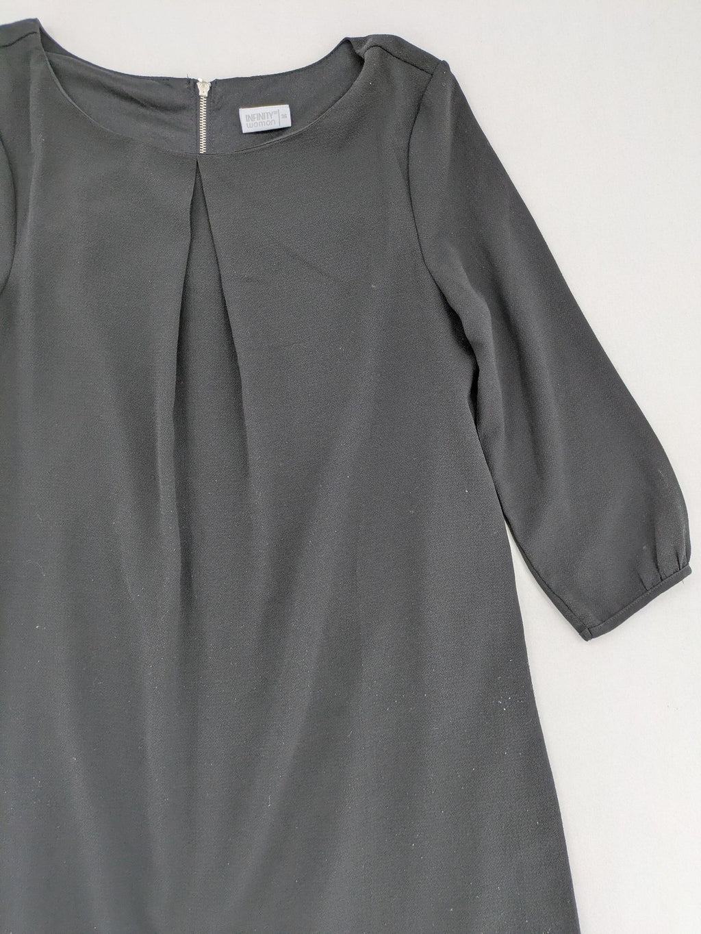 Infinity grey bridal party dress with pleated front and 3/4 sleeves.