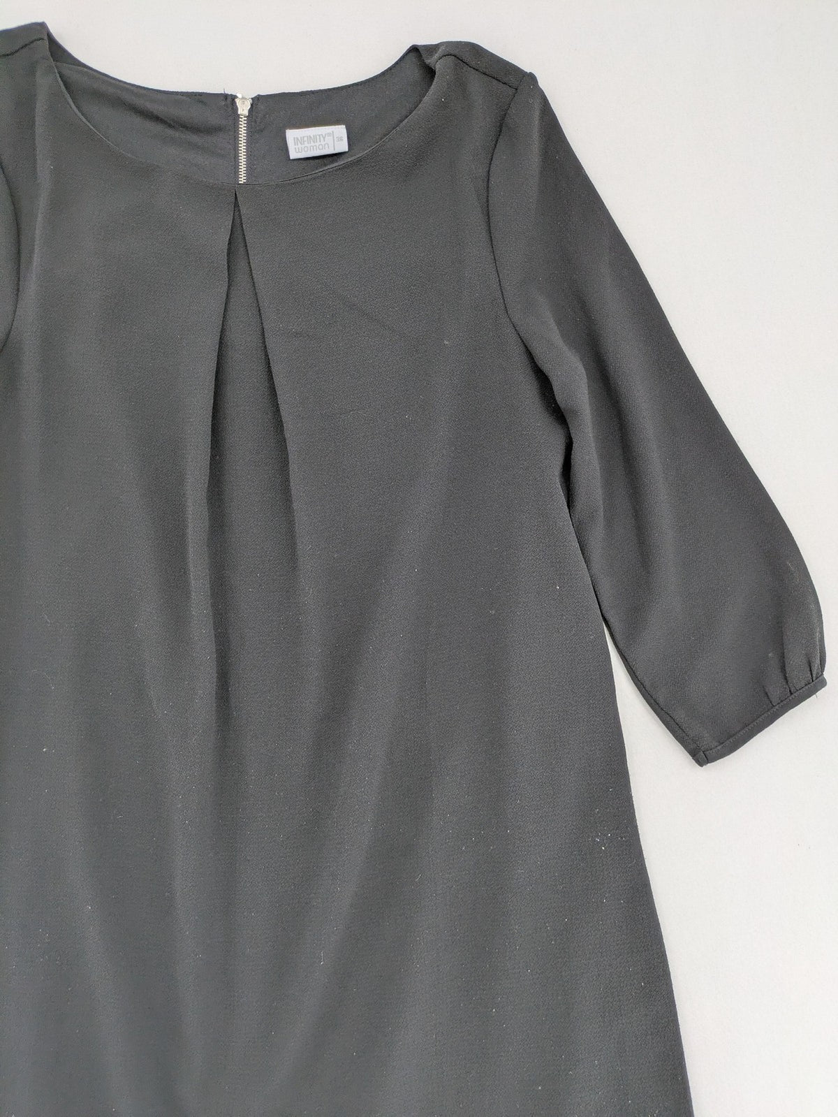 Infinity grey bridal party dress with pleated front and 3/4 sleeves.