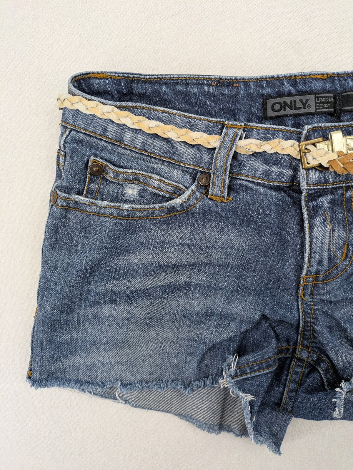 ONLY cream denim shorts with frayed hem and decorative braided gold belt