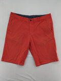 Chino orange shorts flat front with Est. 1921 label and comfortable fit.