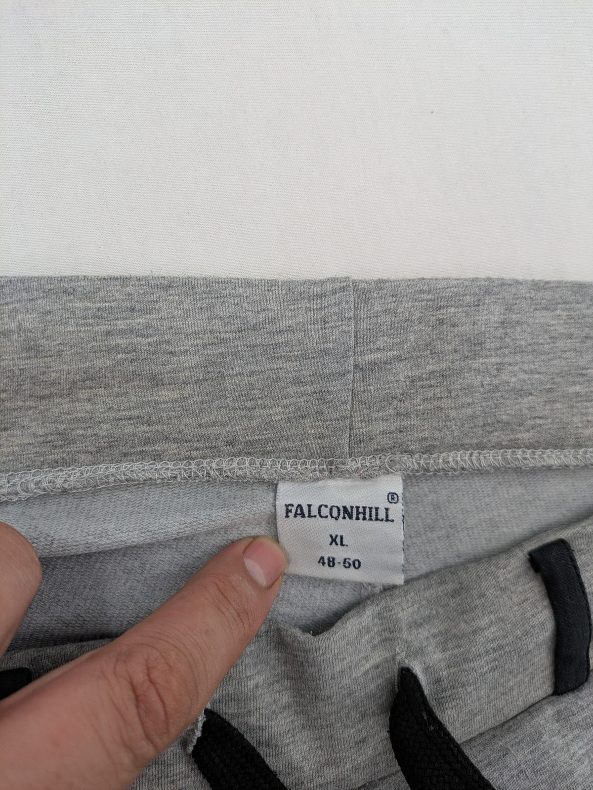 Falconhill grey jogging pants with elastic waistband, drawstring, and stylish black accent pockets.