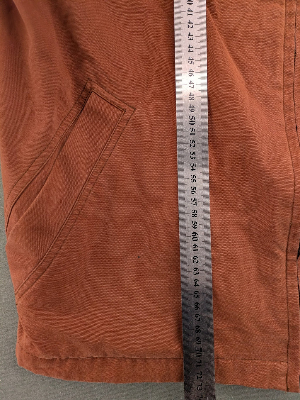 Camel Collection brown jacket with orange contrast collar and embroidered logo.