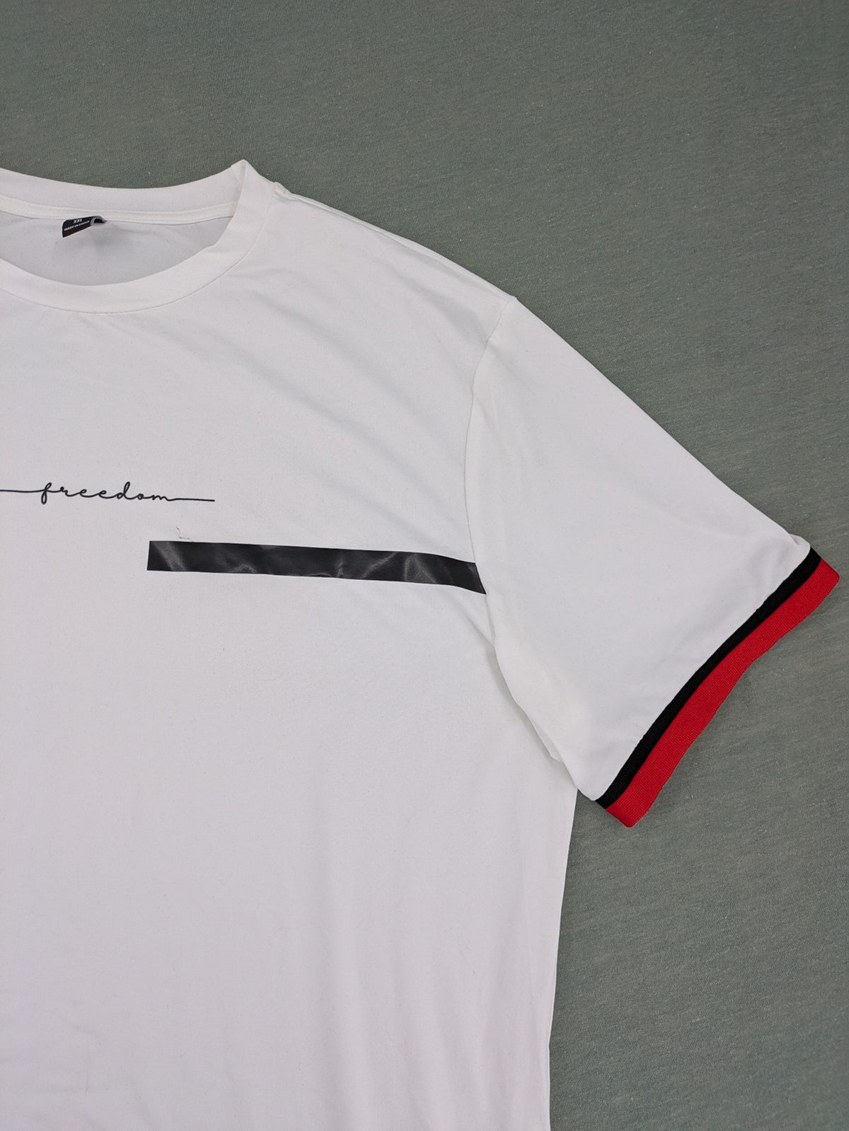 Manfinity black and white outfit set with red accents and "Freedom" graphic print.