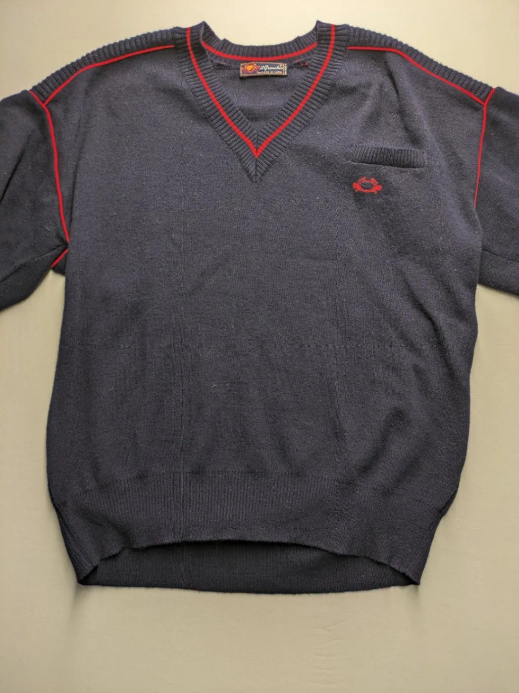 Il Granchio grey turtle neck jumper with red accents and embroidered crab logo.