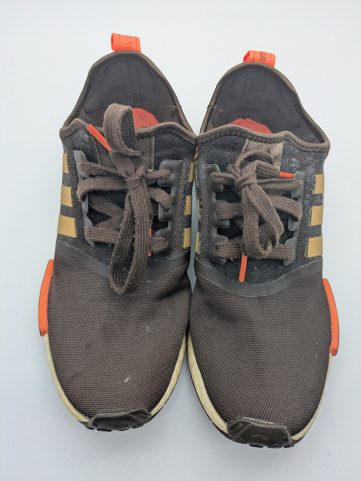 Adidas NMD R1 sneakers brown with tan stripes and bright orange accents, Boost sole.