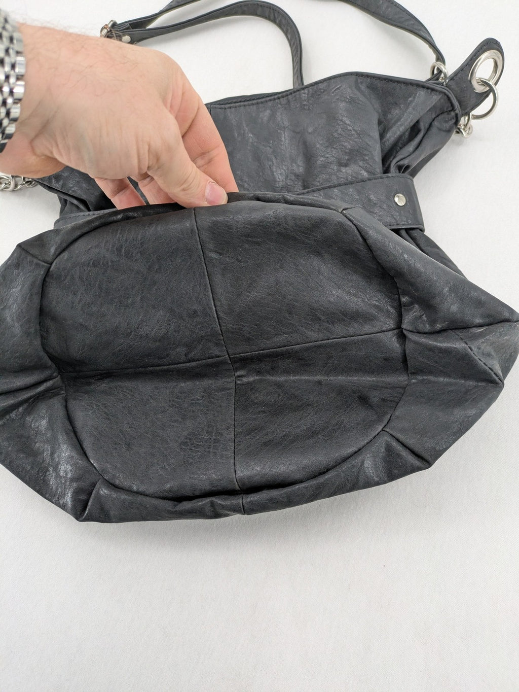 New Yorker black hobo handbag with silver chain details and large eyelets.