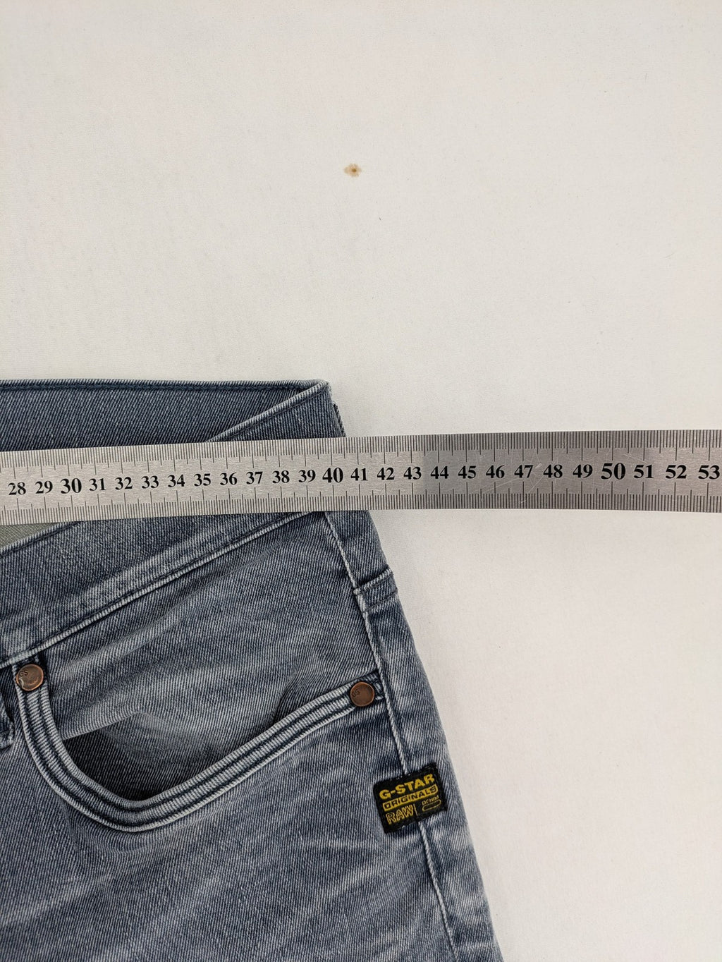 G-Star Raw grey denim straight jeans with classic button fly and subtle branding details.