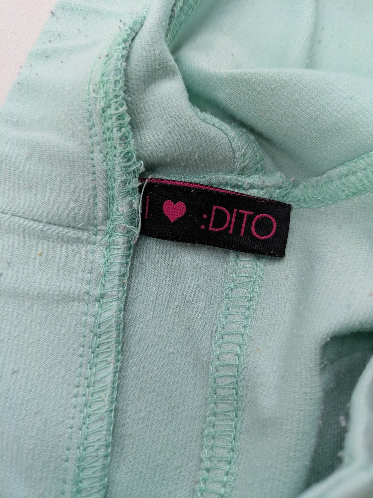 Dito green treggings with pull-on design, front pockets, and belt loops.