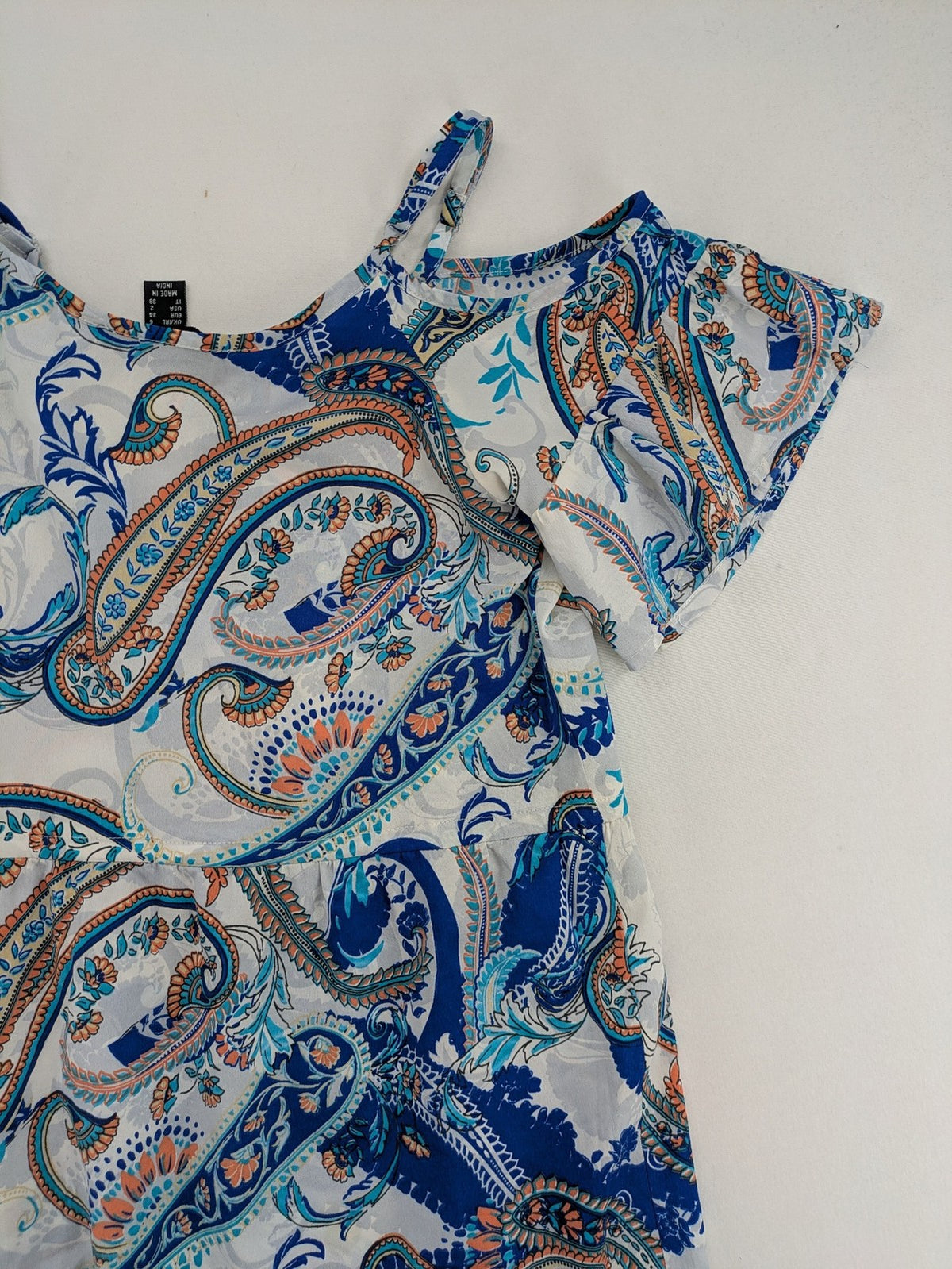 Atmosphere orange summer dress with colorful paisley pattern and cold shoulder design.