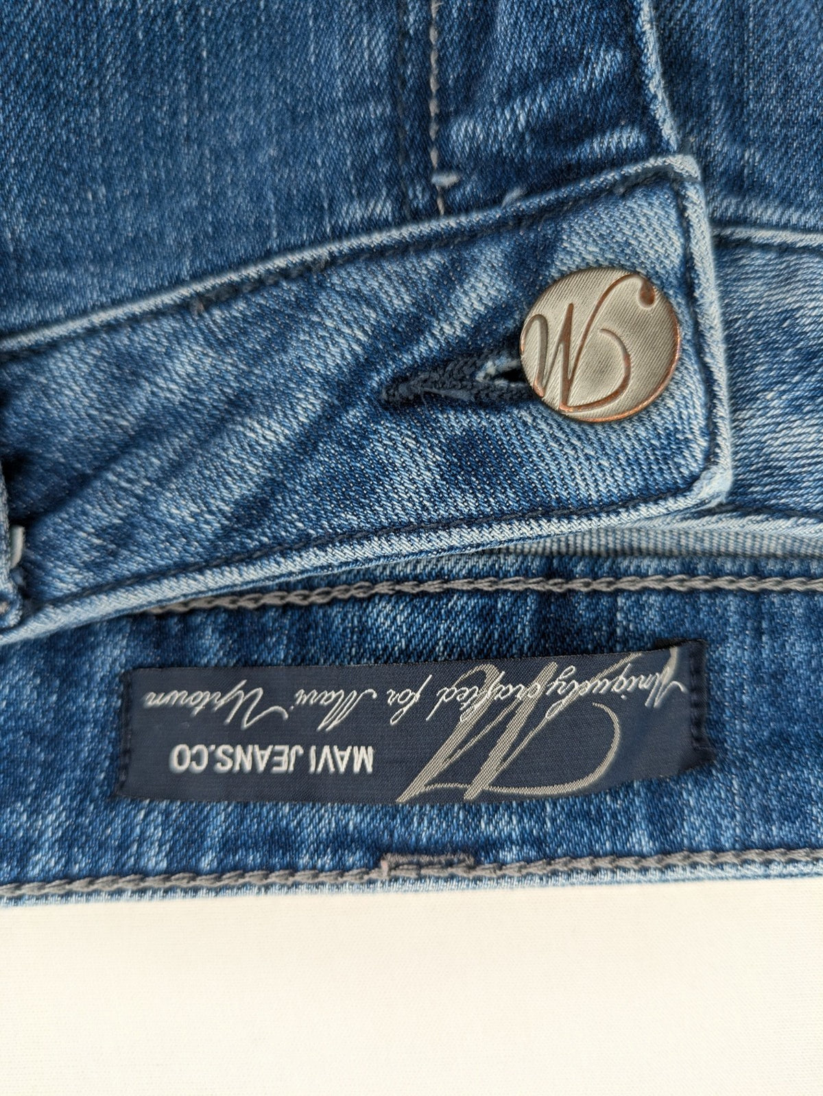 Mavi blue straight leg jeans with classic 5-pocket styling and medium wash.