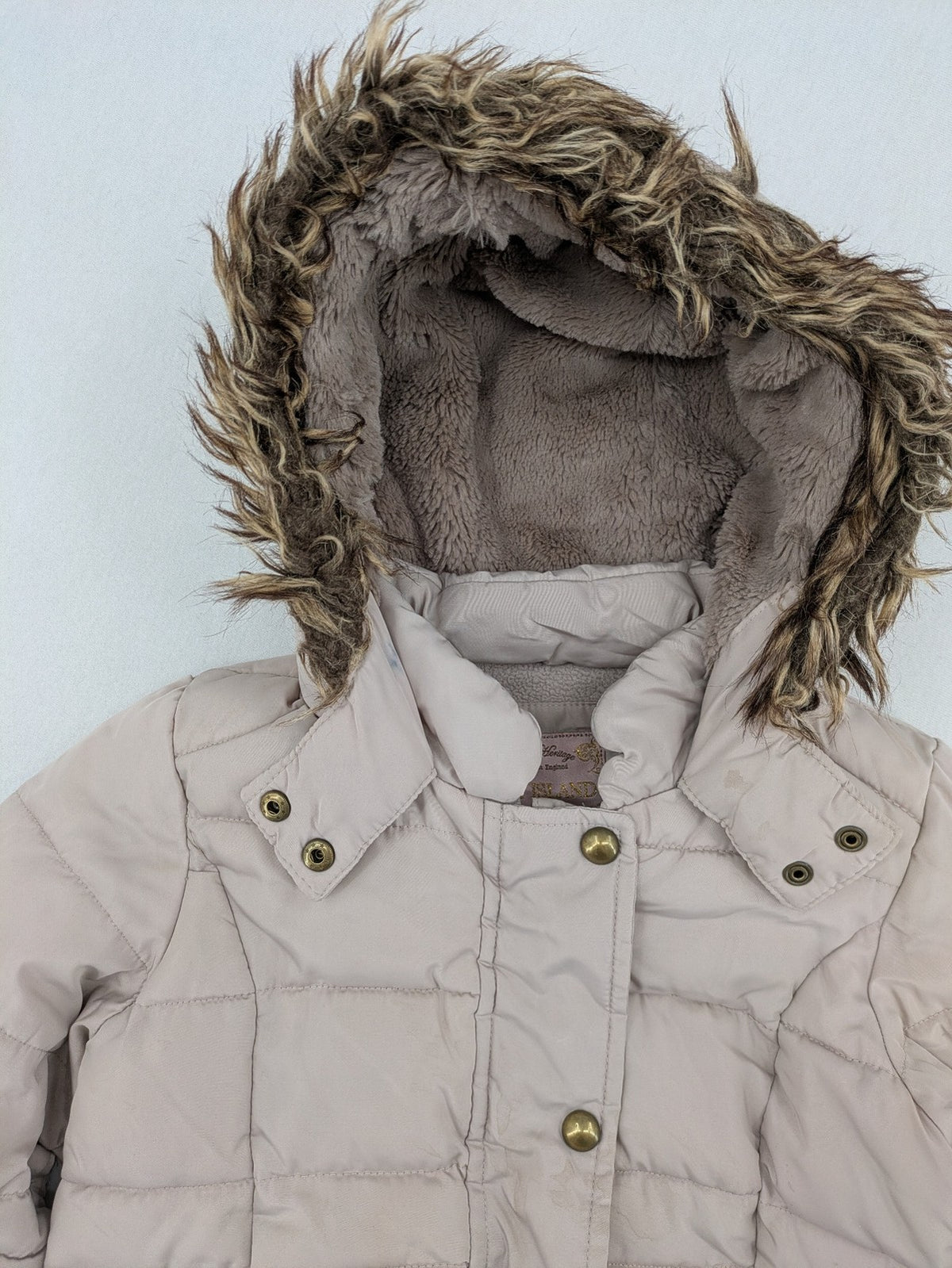 Brit Island beige puffer coat with fleece lining and faux fur hood detail.