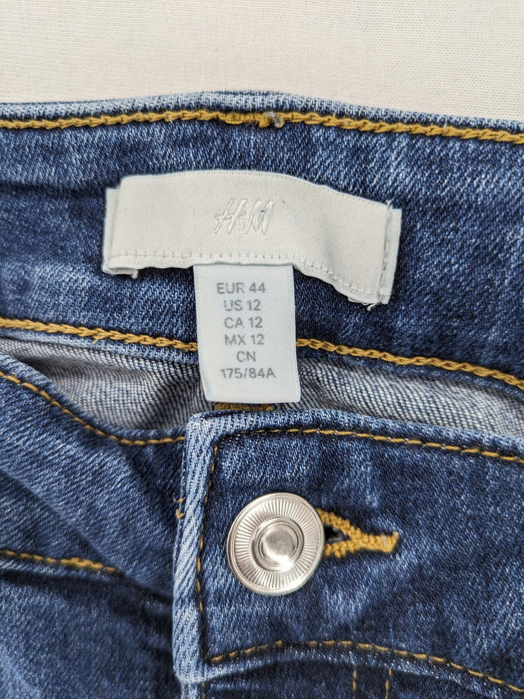 H&M blue skinny jeans with stretch denim and slim fit design.