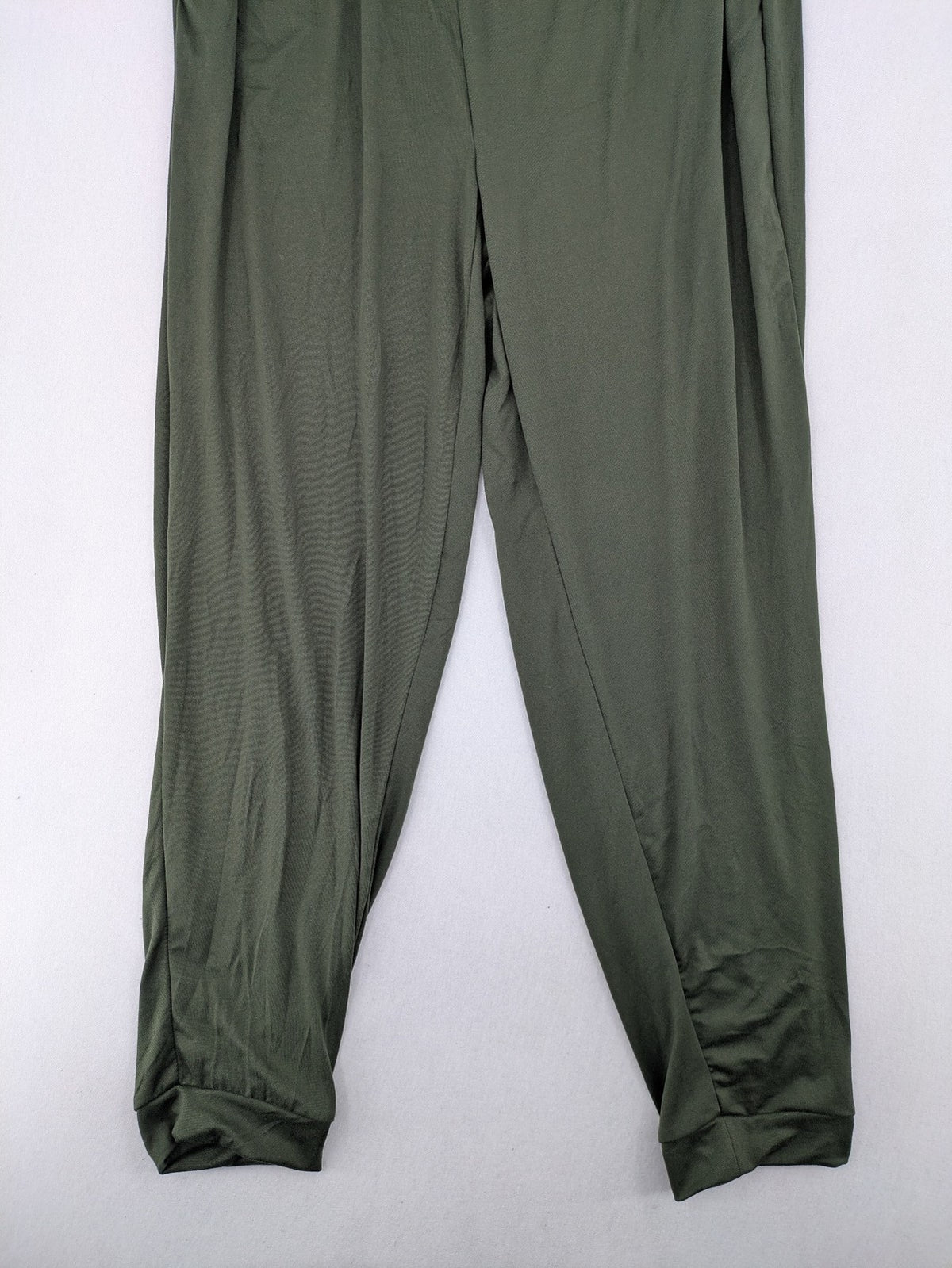 Infinity green jogger pants with elastic waistband and side pockets, soft stretch material.