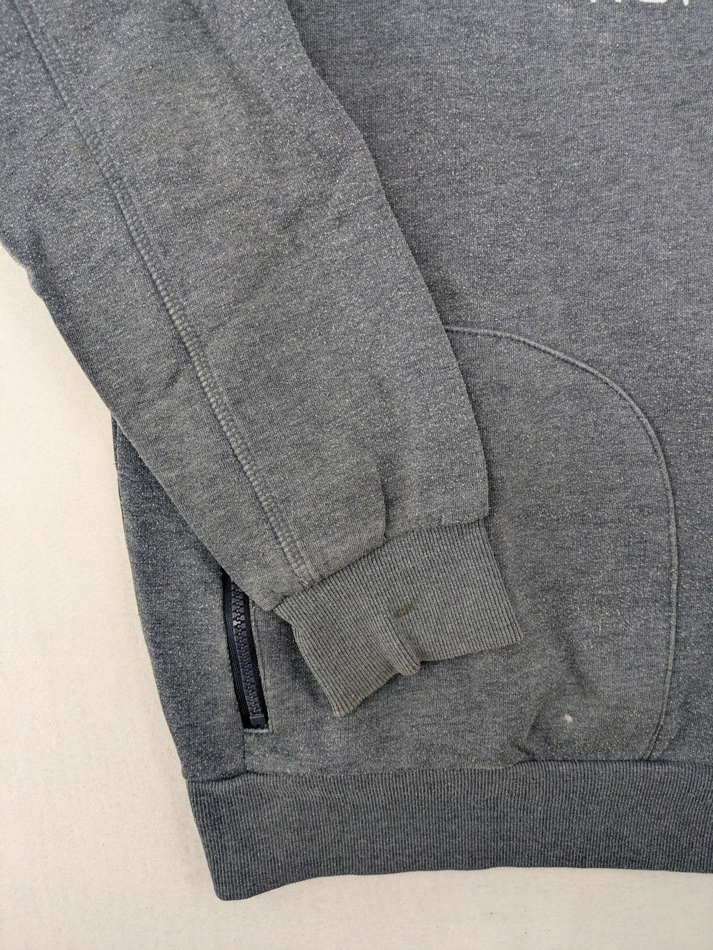 C&A grey hoodie with embossed chest logo, teddy-lined hood, and side zip pockets.