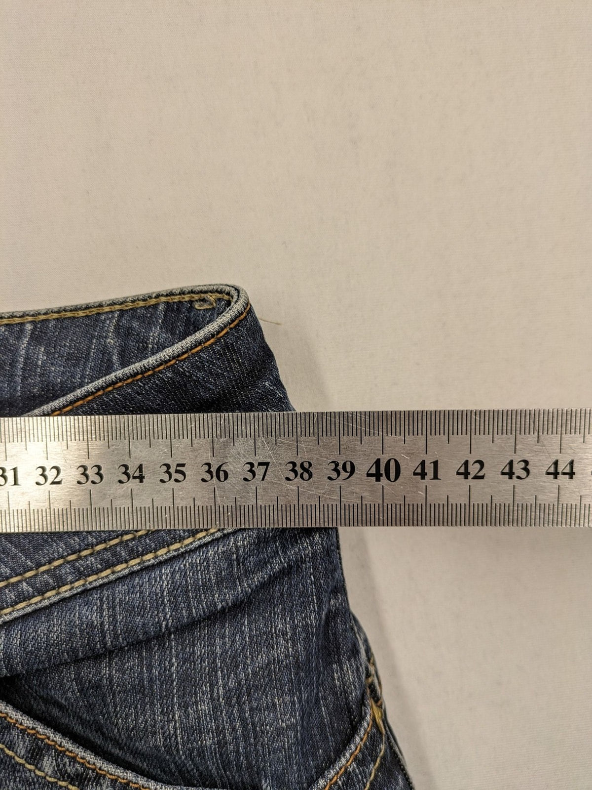 Tommy Hilfiger Denim blue straight jeans with low rise and slight used effects.