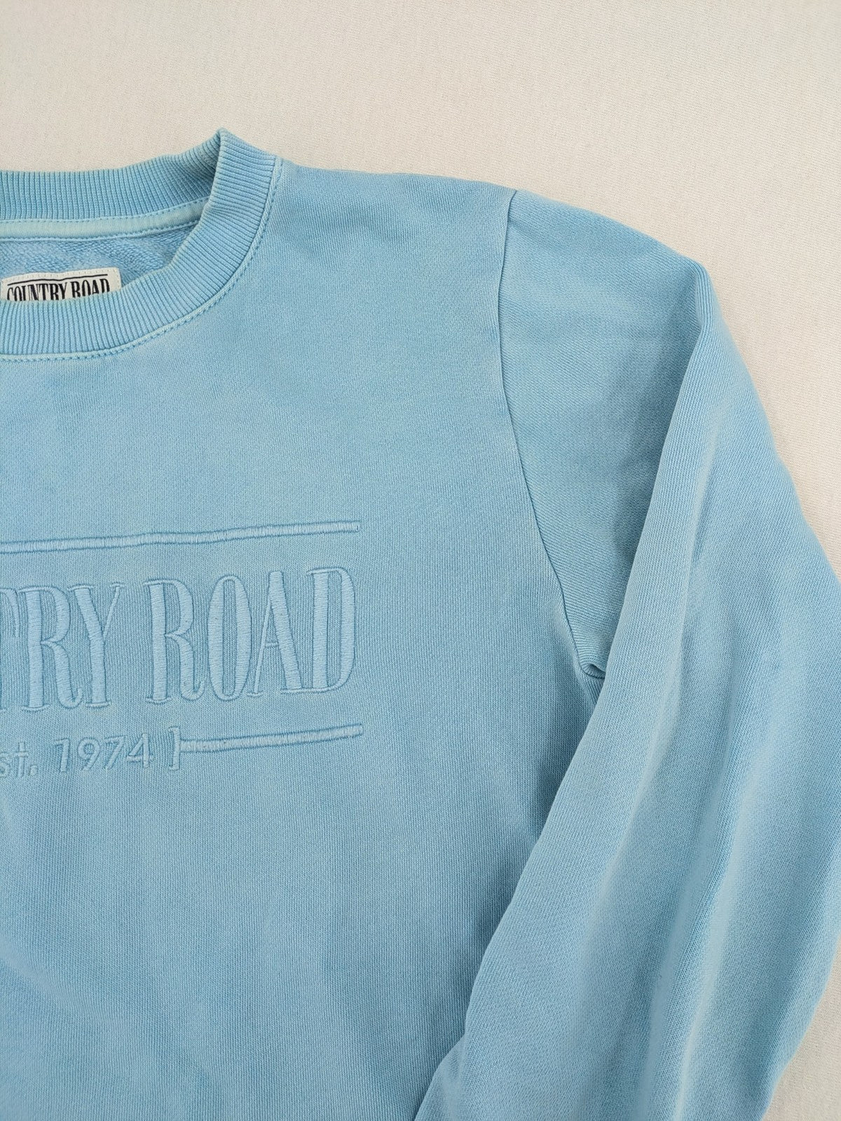 Country Road blue turtle neck jumper with embossed logo on chest, made from cotton.