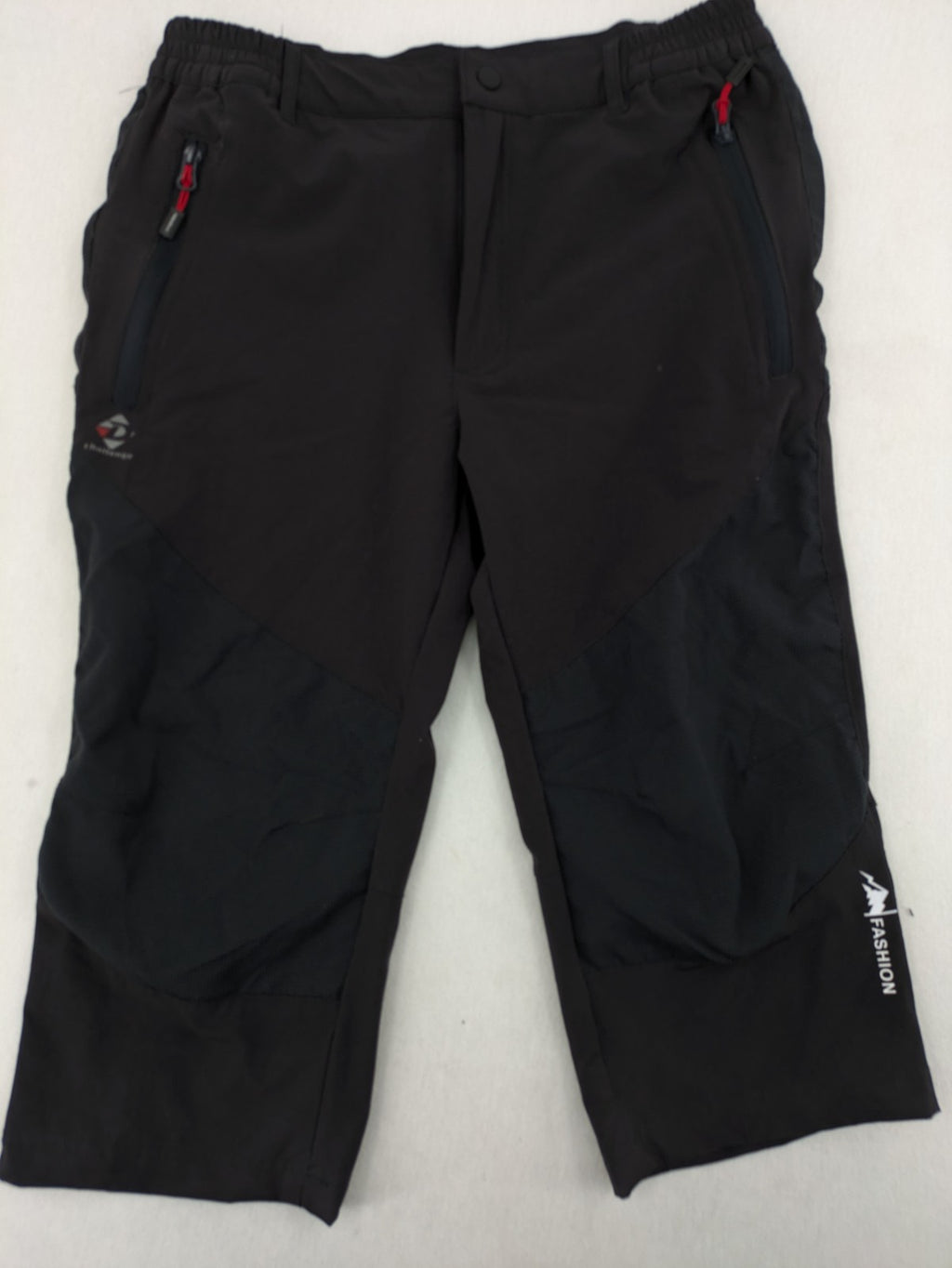 Outdoor black capri pants with elastic waistband and multiple zippered pockets.