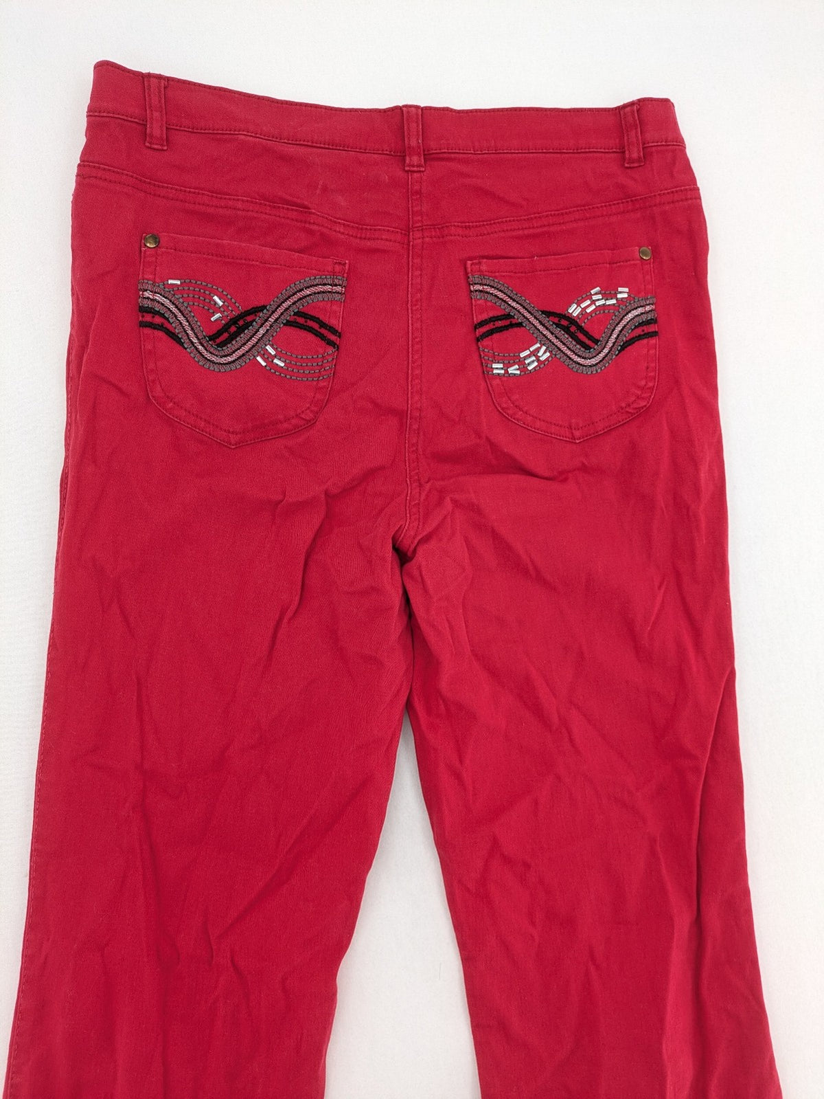 Jet Line red bootcut jeans with embroidered back pockets and pearl embellishments.