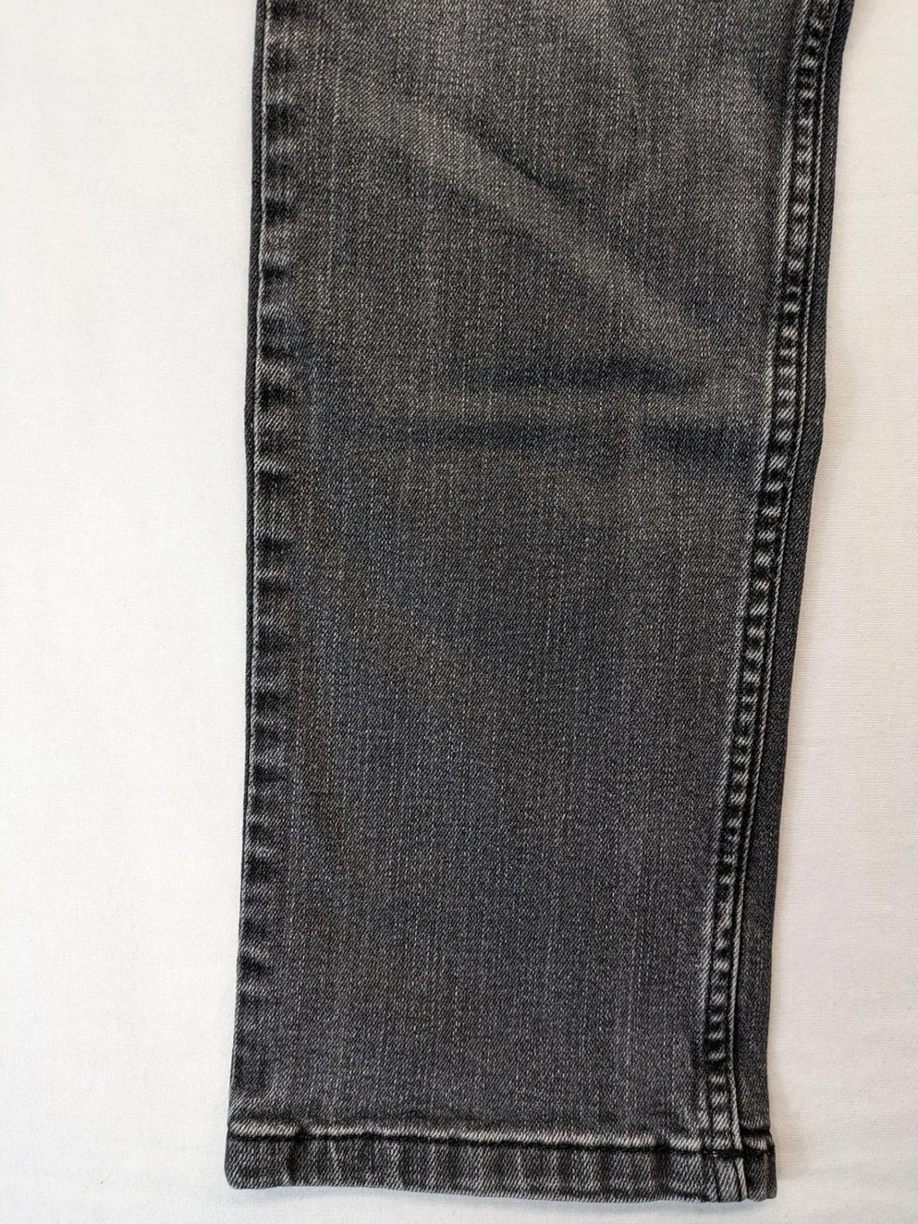 Denim grey straight jeans 5-pocket design with subtle brand details and zipper closure.
