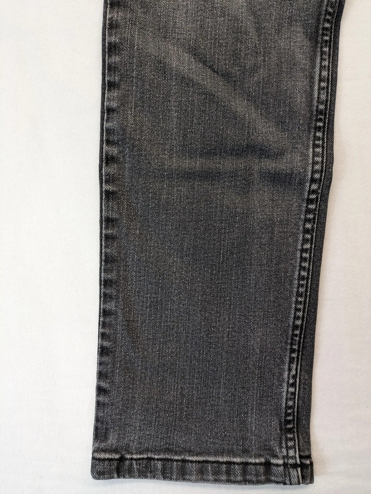 Denim grey straight jeans 5-pocket design with subtle brand details and zipper closure.