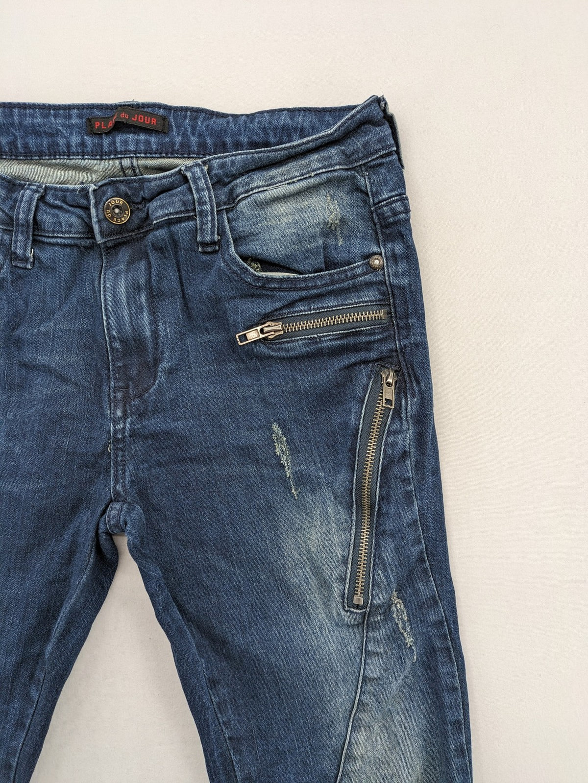 Place du Jour blue biker jeans with zippers, used-look wash, and star rivet detail.
