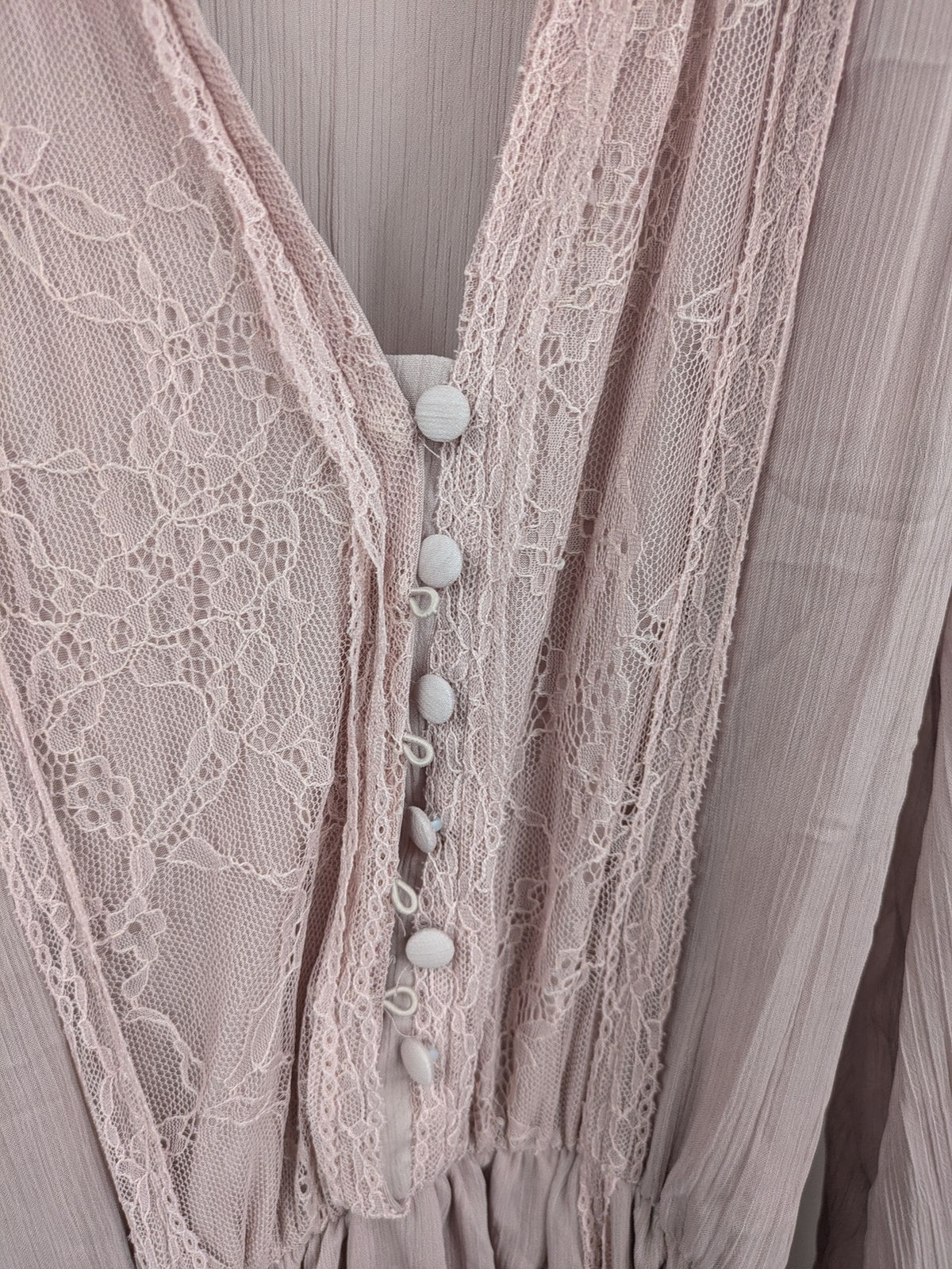 Zara pink midi dress with lace V-neck, pleated fabric, and long bishop sleeves.