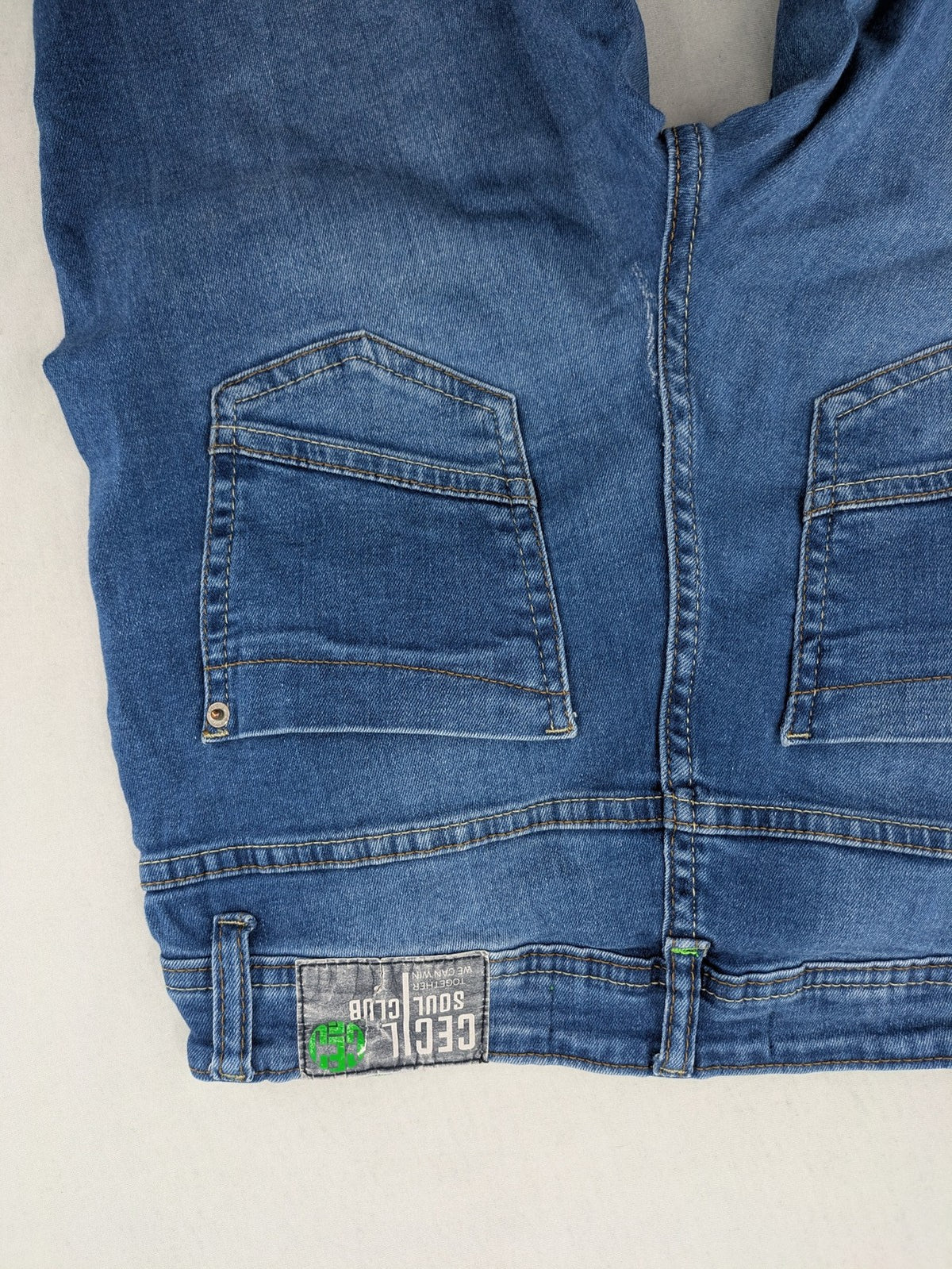 Cecil blue straight jeans with neon green accents and classic 5-pocket design.