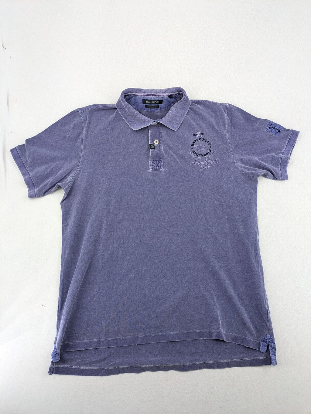 Marc O'Polo purple polo shirt garment dyed cotton with embroidered logo and intricate details.