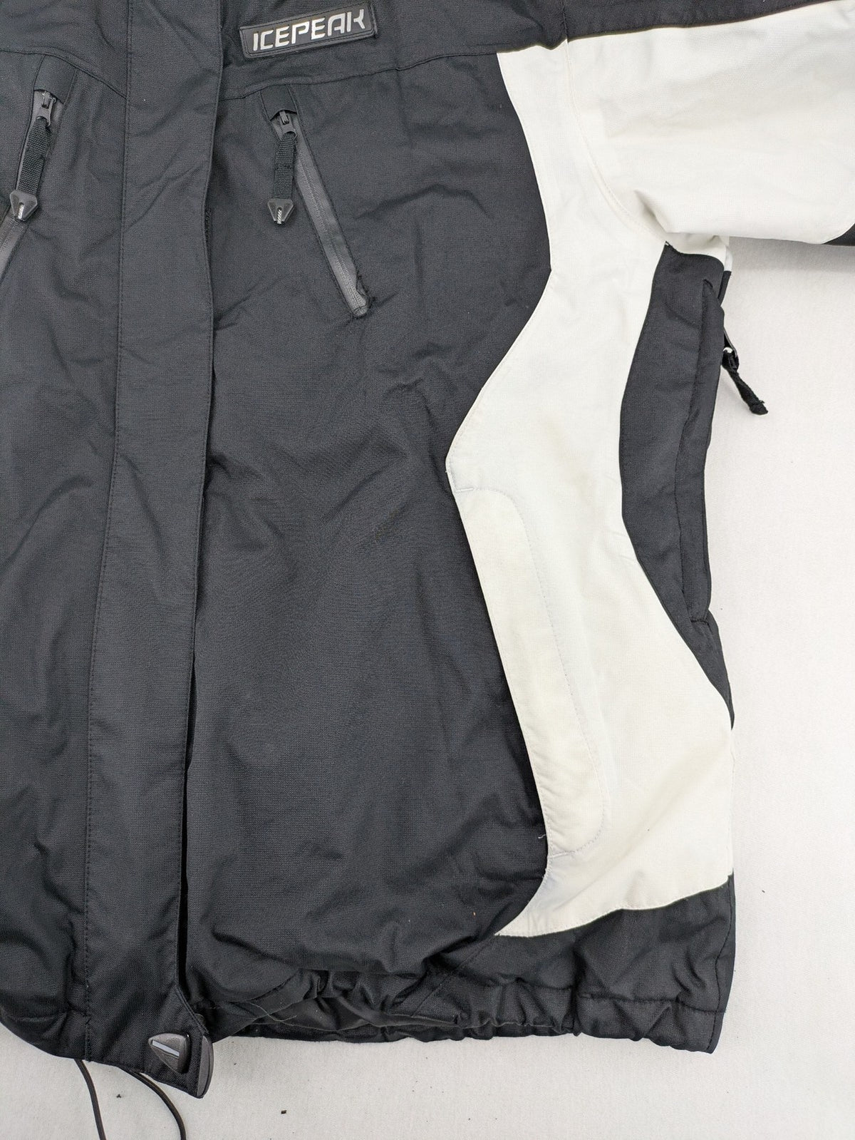 Icepeak black and white ski snowboard jacket with RECCO logo and quilted insulation.