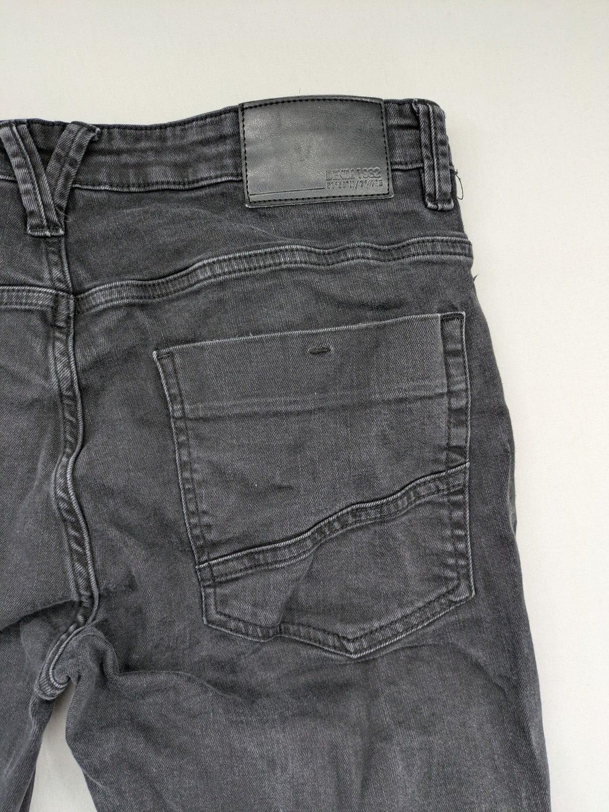 Denim 1982 grey slim fit jeans with ripped knee detail and distressed finish.