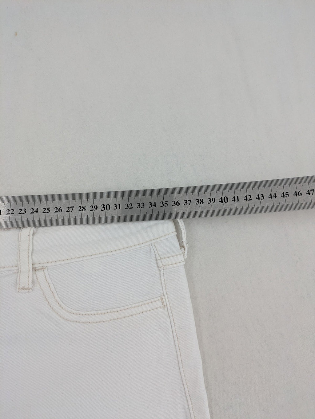Hollister white super skinny high rise jeans with classic 5-pocket design and zipper closure.