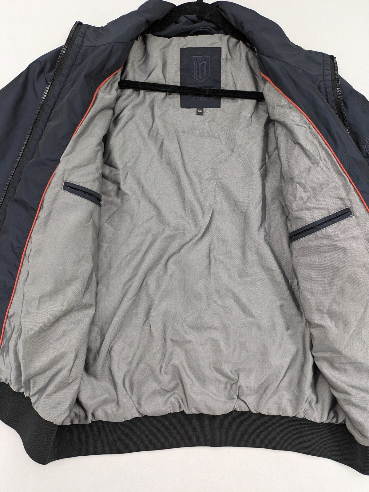 Radloff grey navy bomber jacket with orange contrast stitching and zippered pockets.